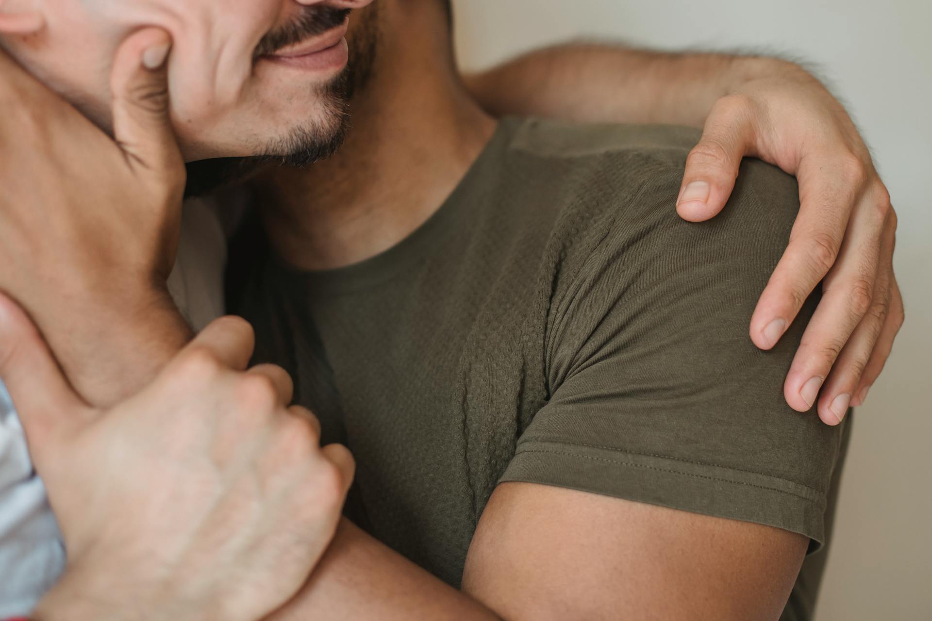 A closeup shot of a gay couple embracing | Source: Pexels