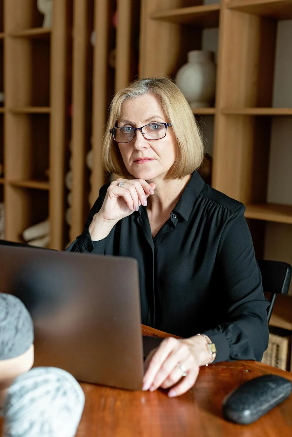 A serious woman looking up from her laptop | Source: Pexels