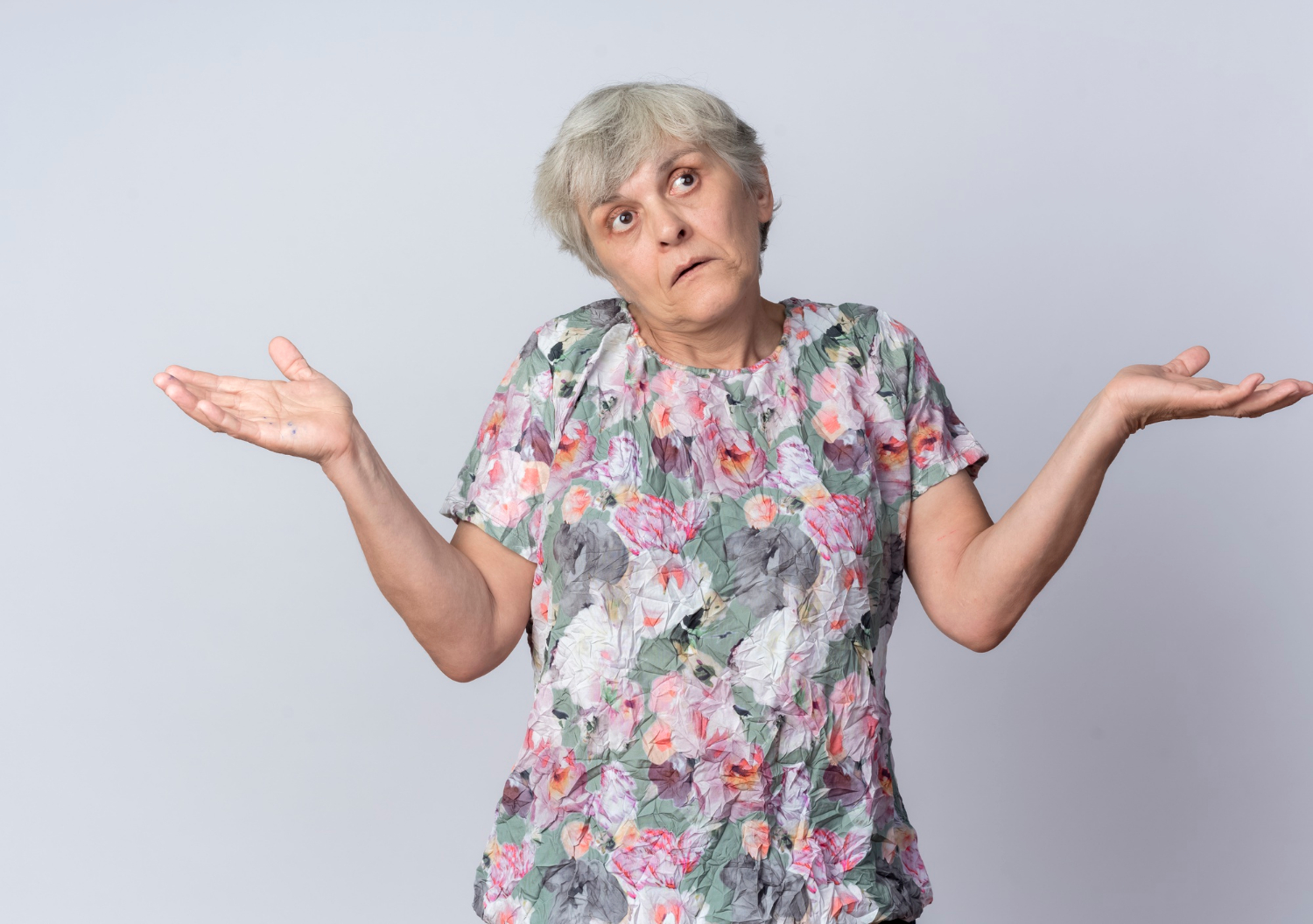 A frustrated senior woman shrugging | Source: Freepik