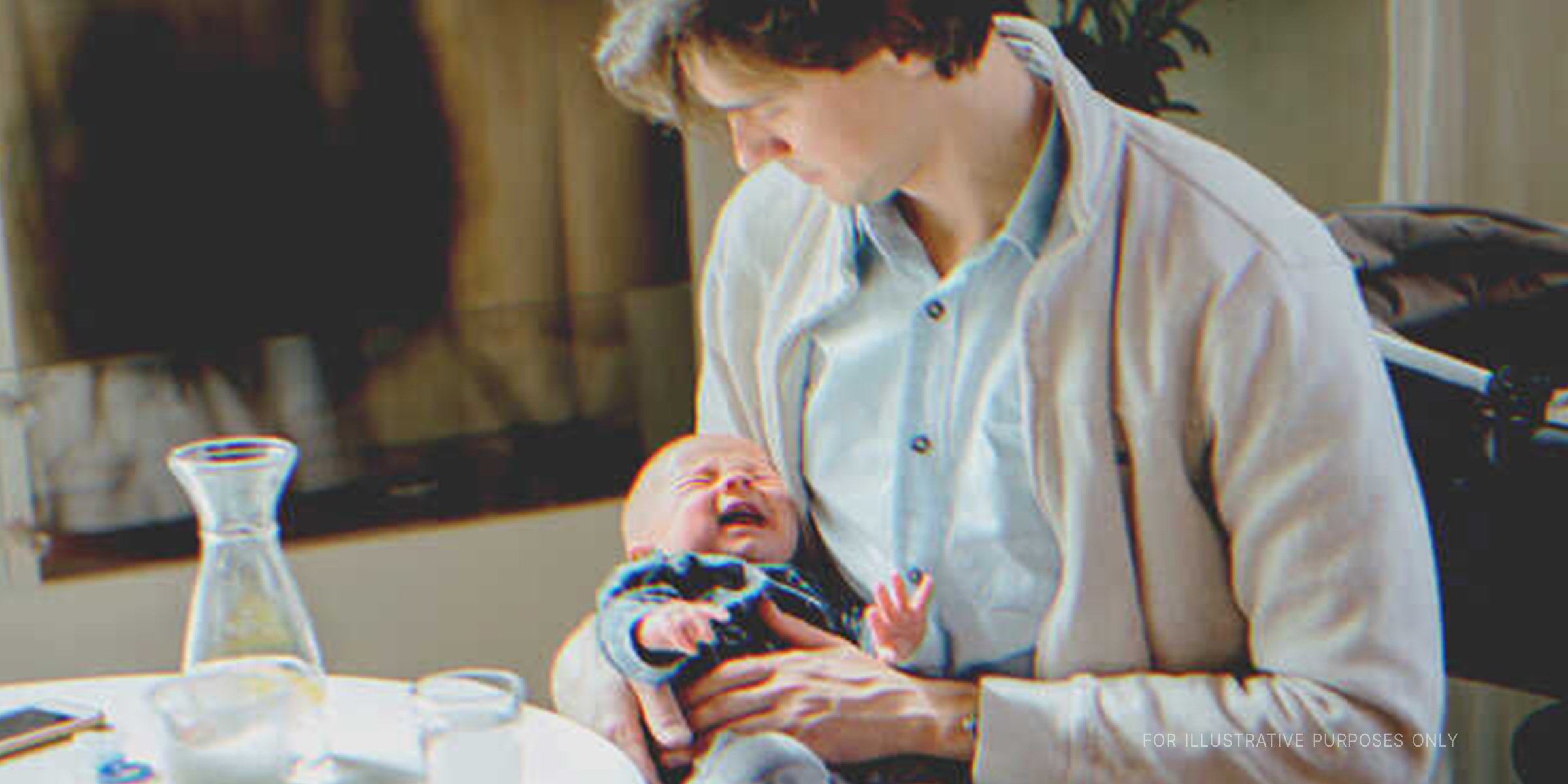 Man With Crying Baby In His Arms. | Source: Shutterstock