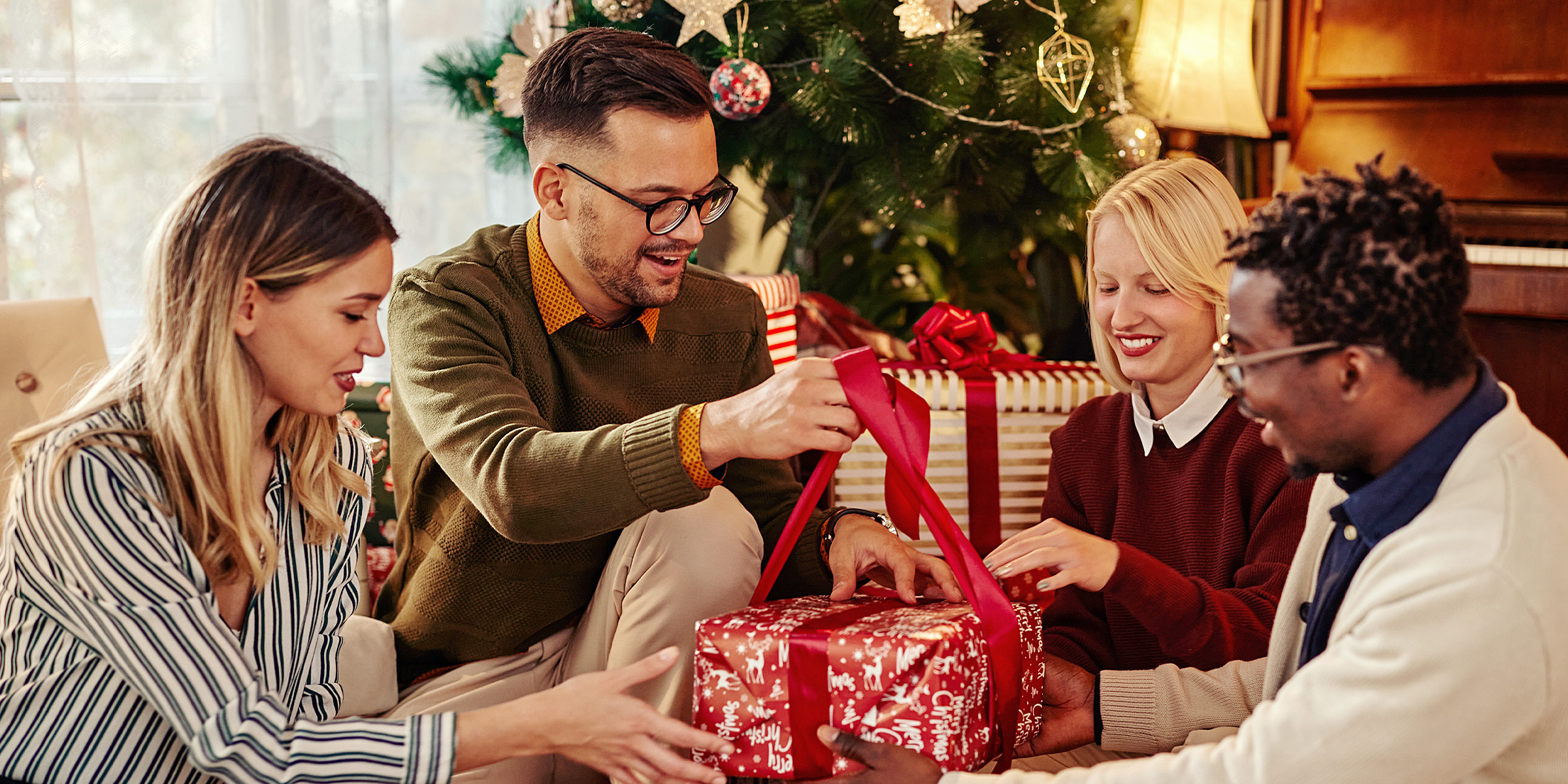 A group of people holding a gift | Source: Shutterstock