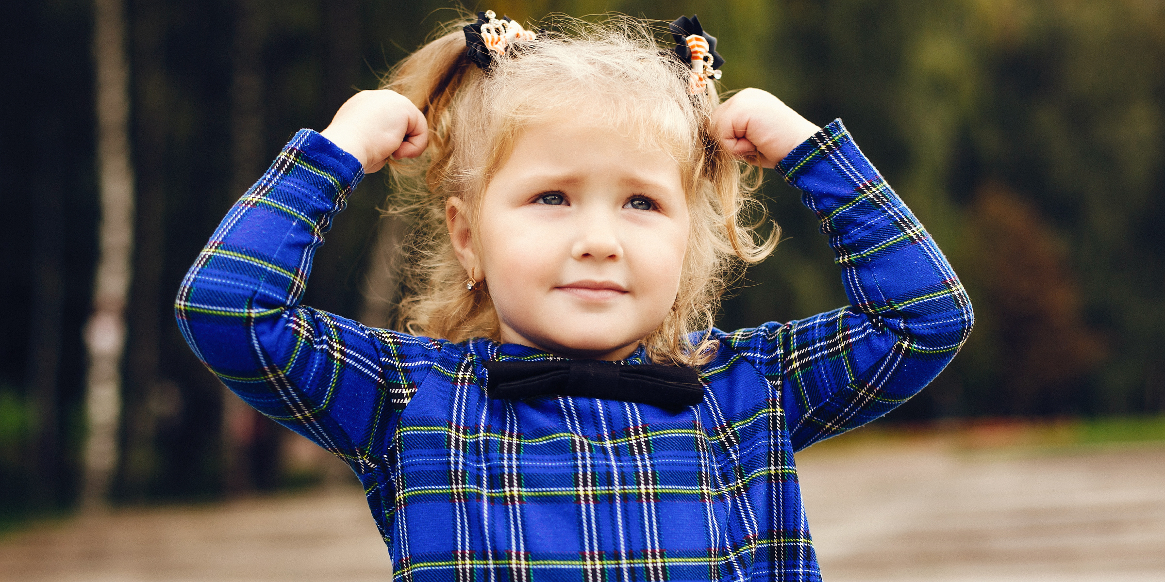 A little girl with her hands on her head | Source: Shutterstock