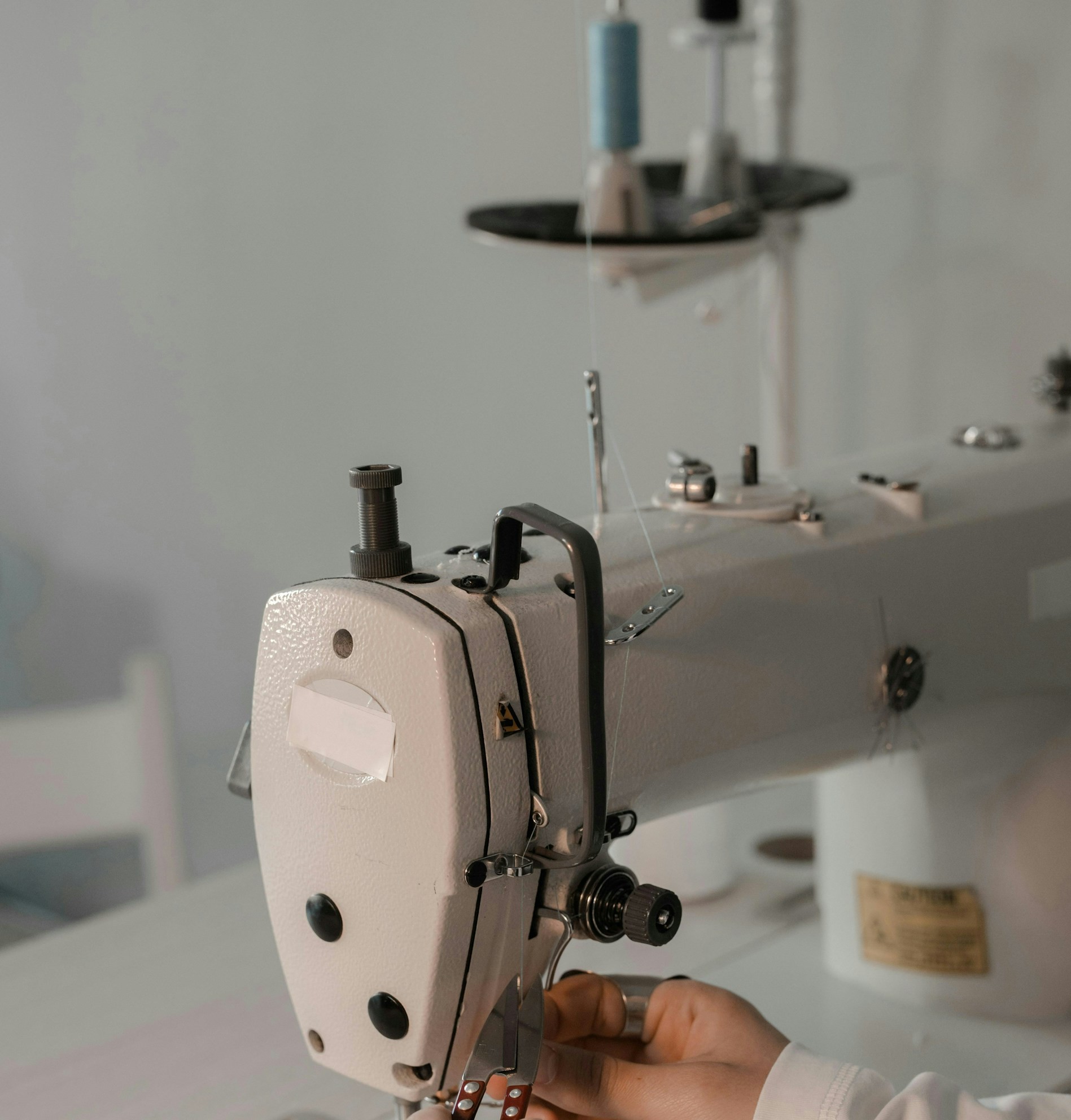 My Sister Excluded My Son from Her Wedding After He Made Her Dress, but Still Expected to Wear It – We Gave Her One Condition to Keep It 14 A person using a sewing machine | Source: Unsplash