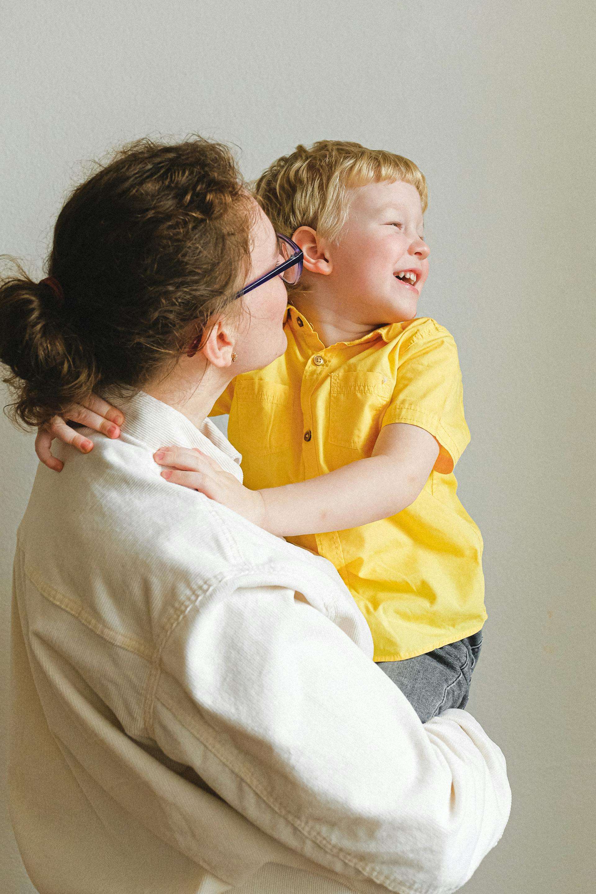 A mother holding her son | Source: Pexels