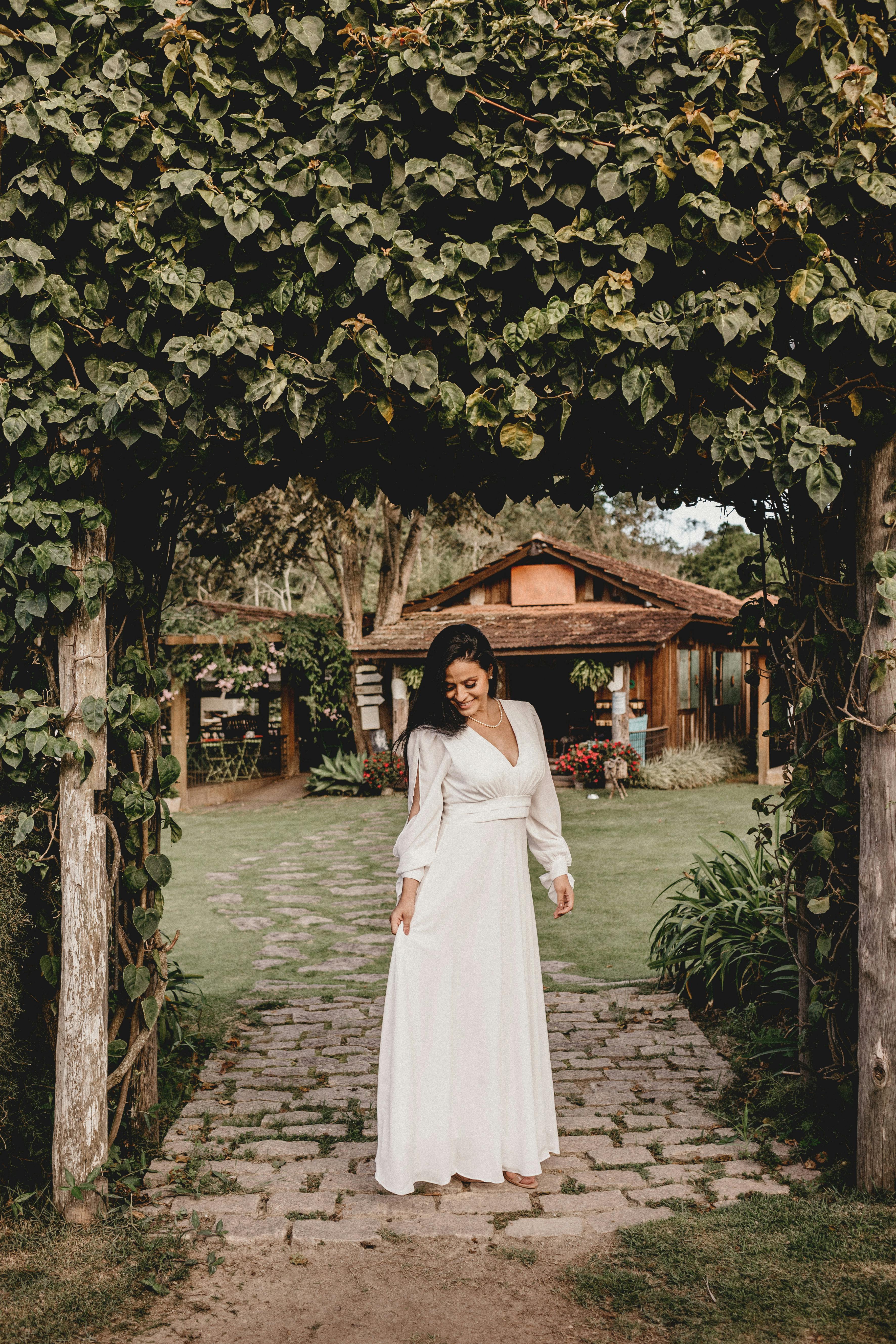 Woman in a white dress smiling | Source: Pexels