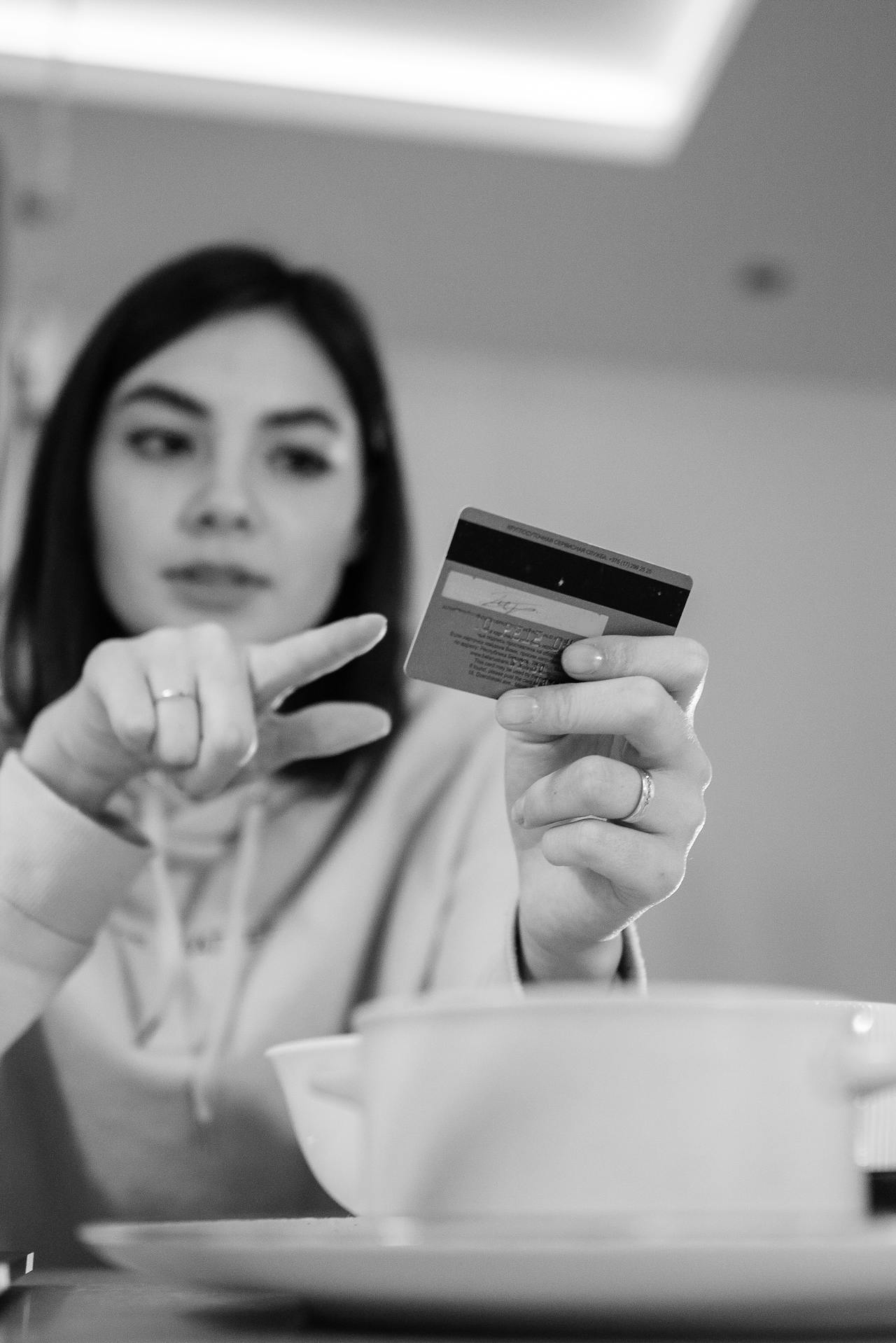 A woman holding her bank card | Source: Pexels