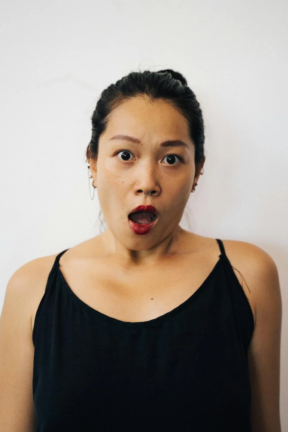 A shocked woman in a black top | Source: Pexels