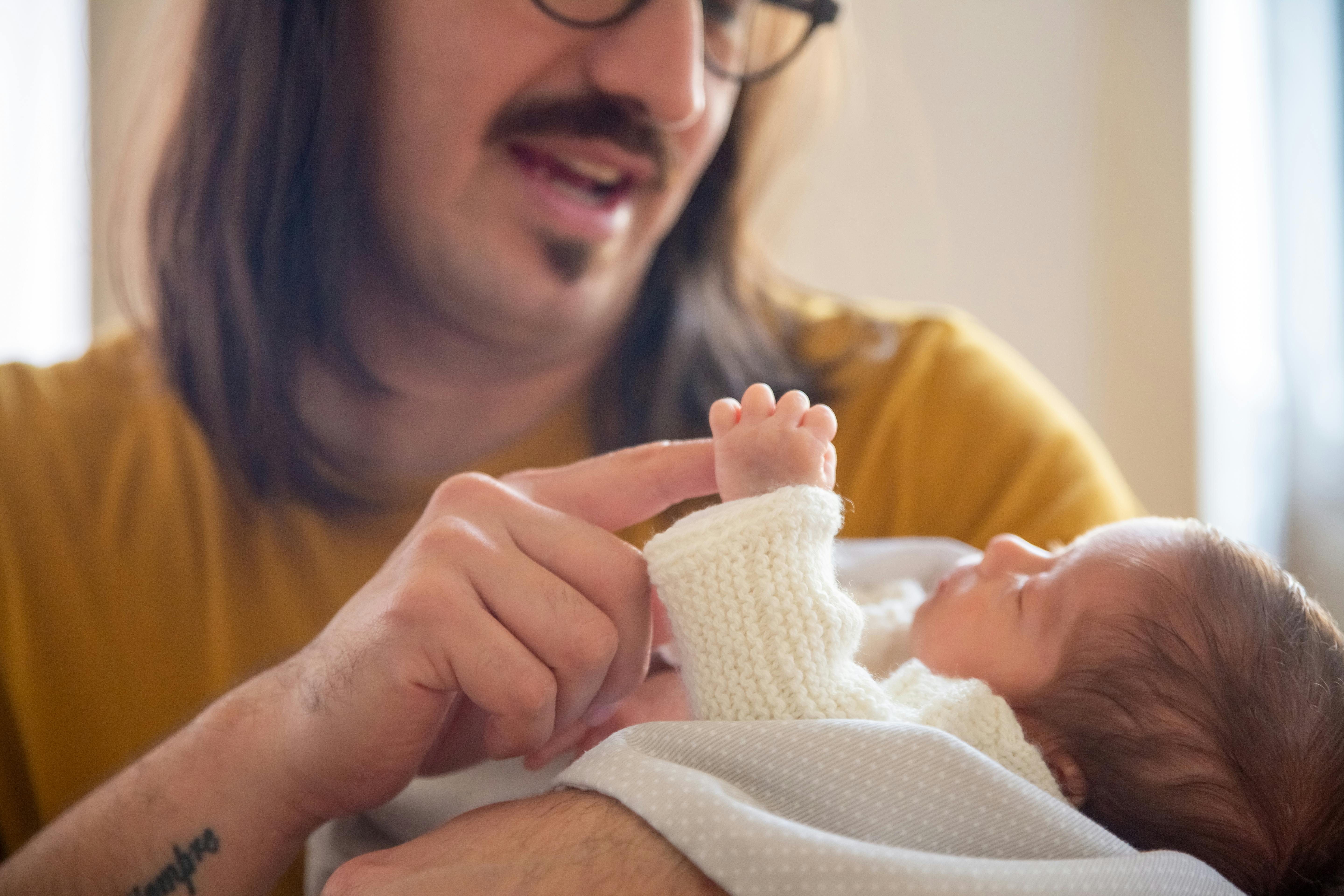 A man playing with a baby | Source: Pexels