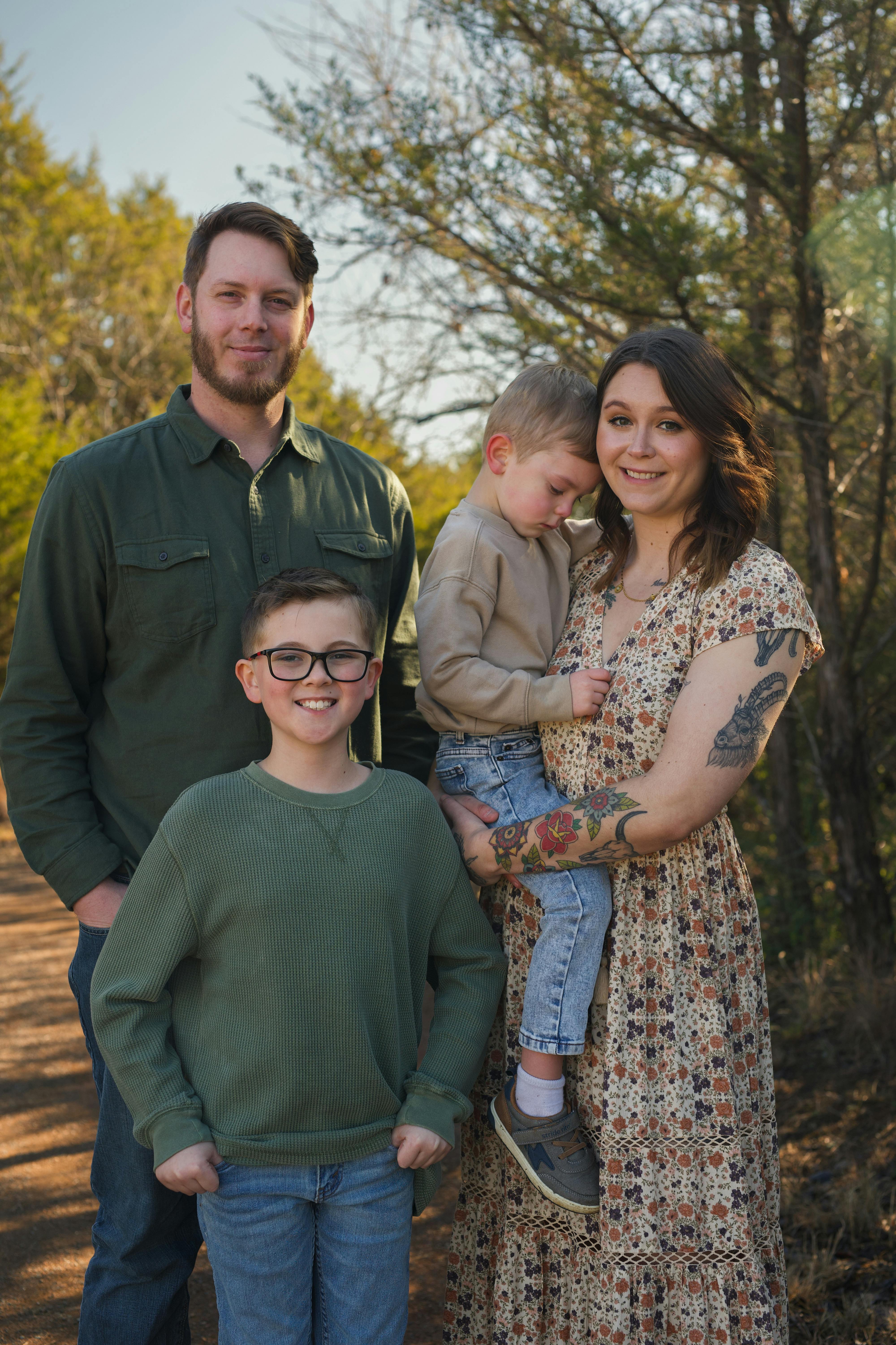 A happy family of four posing together | Source: Pexels