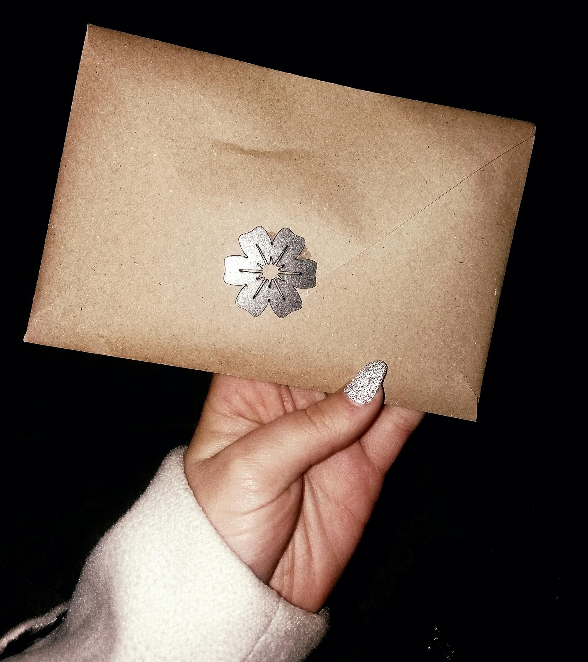 A woman holding an envelope | Source: Midjourney