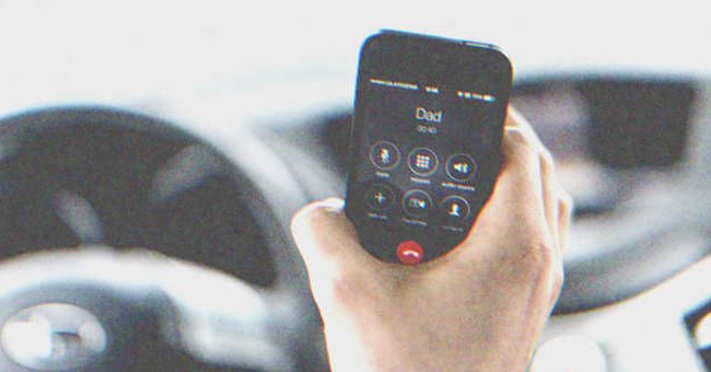 A hand holding a phone with a caller ID on the screen | Source: Shutterstock