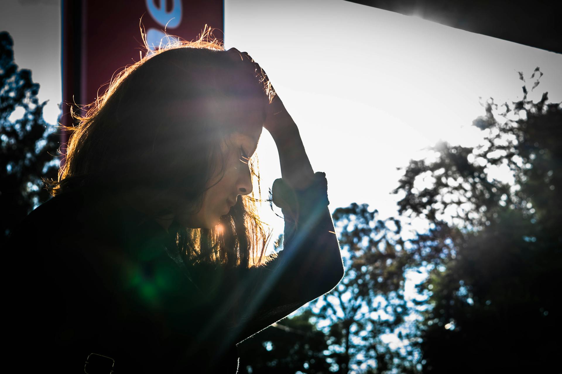 A woman standing with her hand in her hair | Source: Pexels