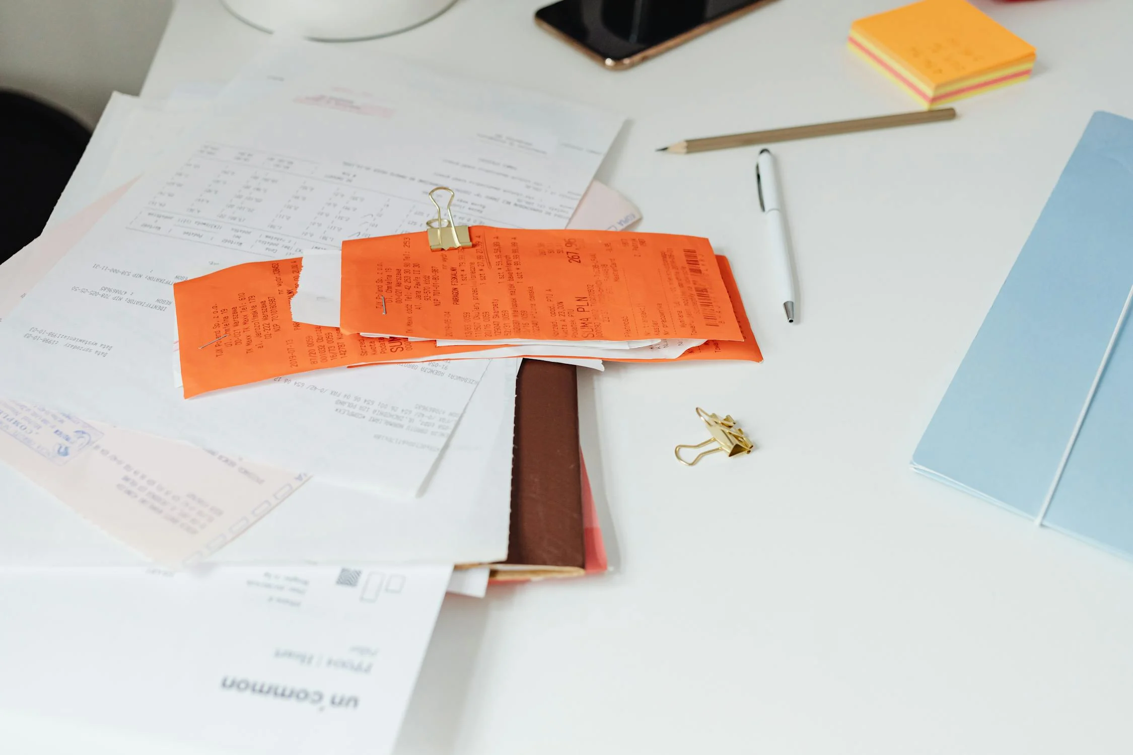 Receipts and invoices on the table | Source: Pexels