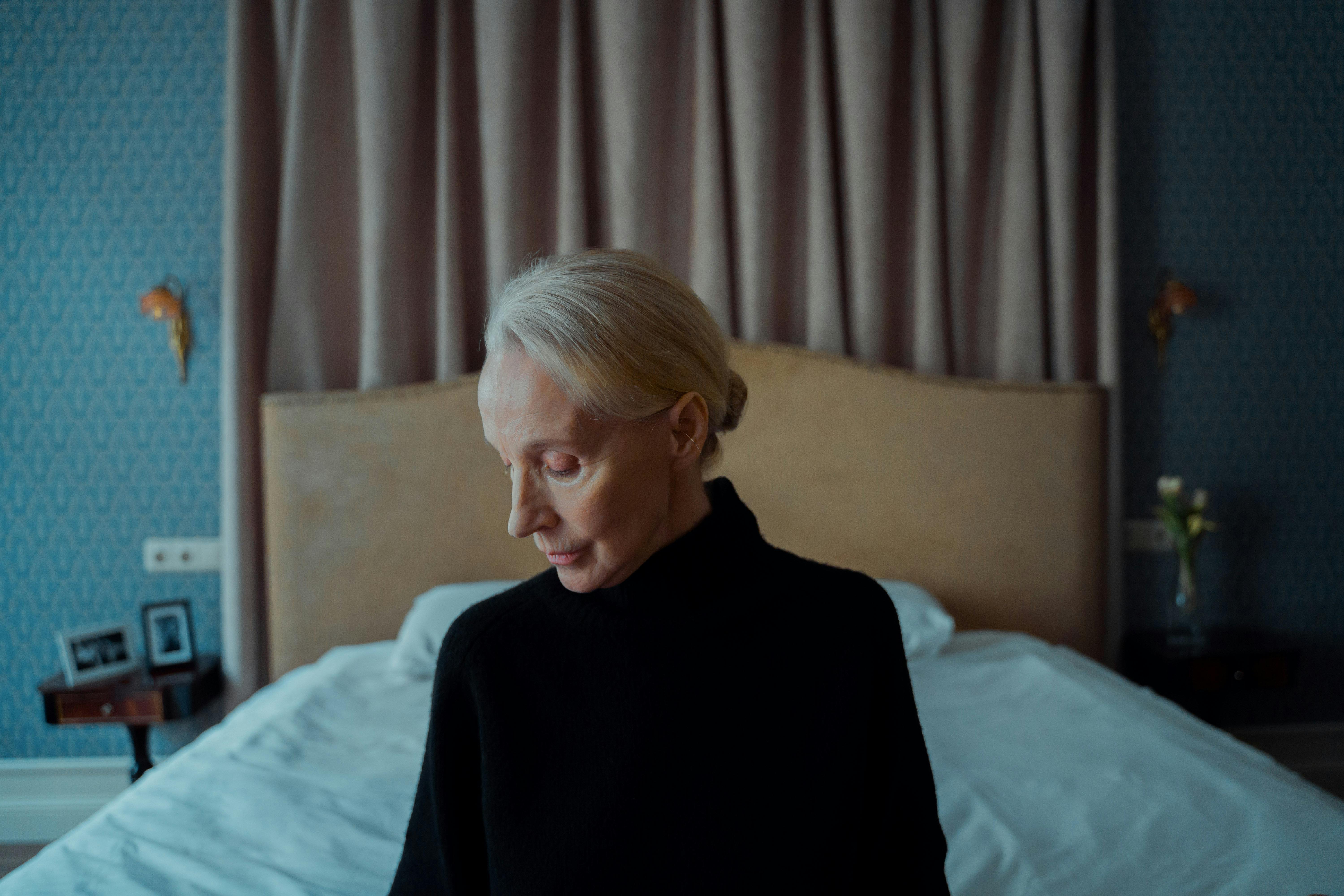 A thoughtful woman sitting on a bed | Source: Pexels