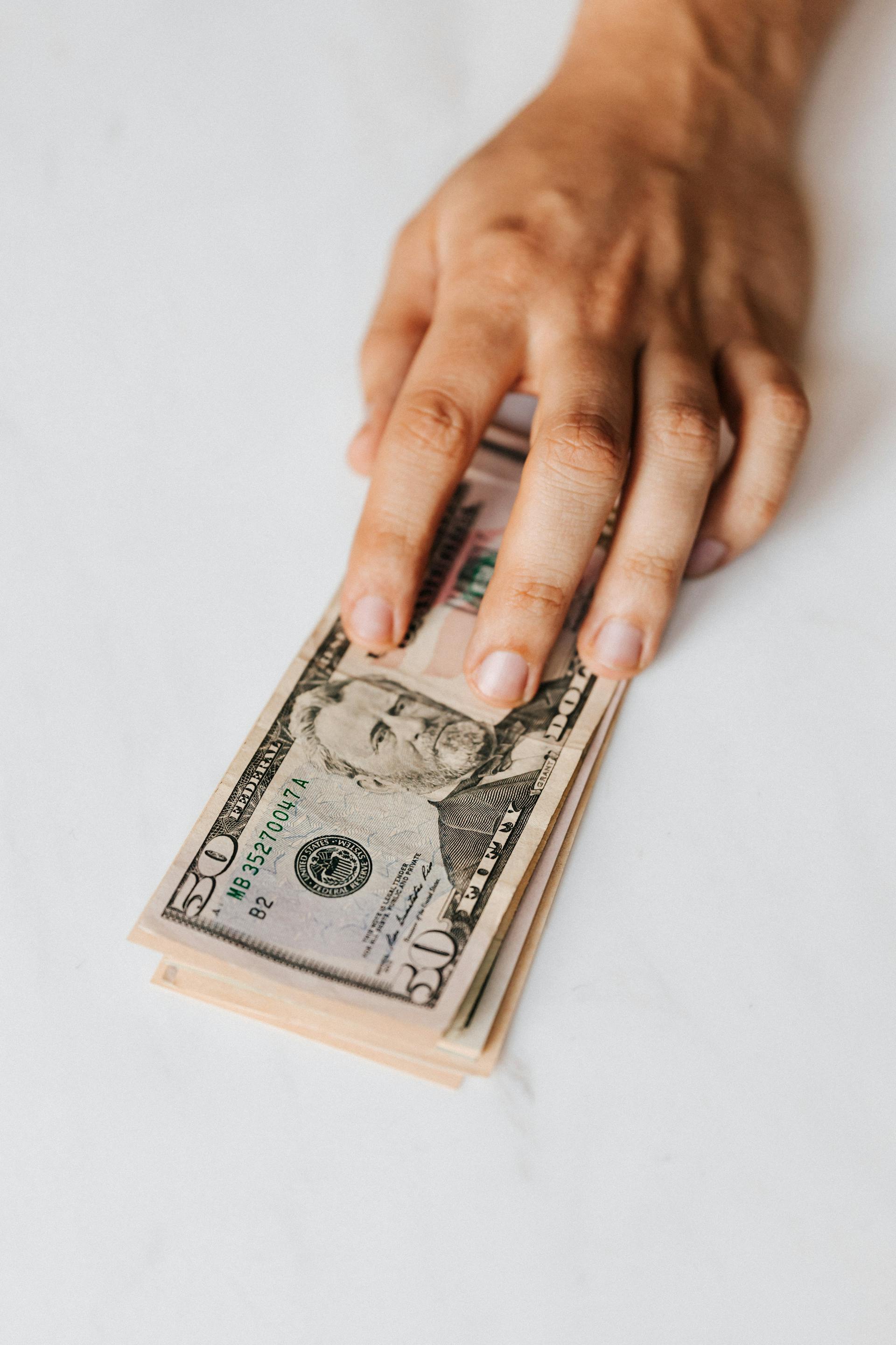 A man holding money | Source: Pexels