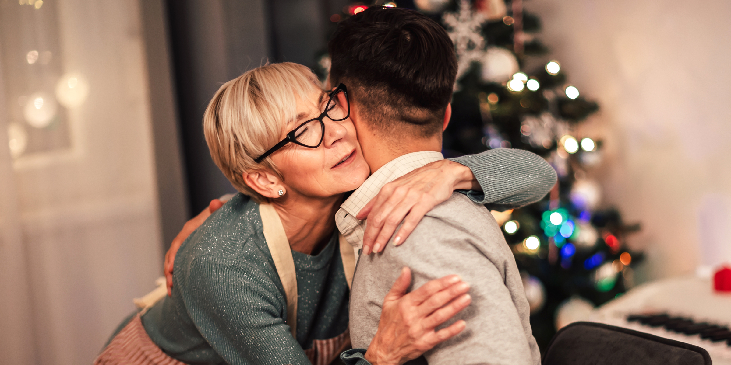 A woman hugging her son | Source: Shutterstock