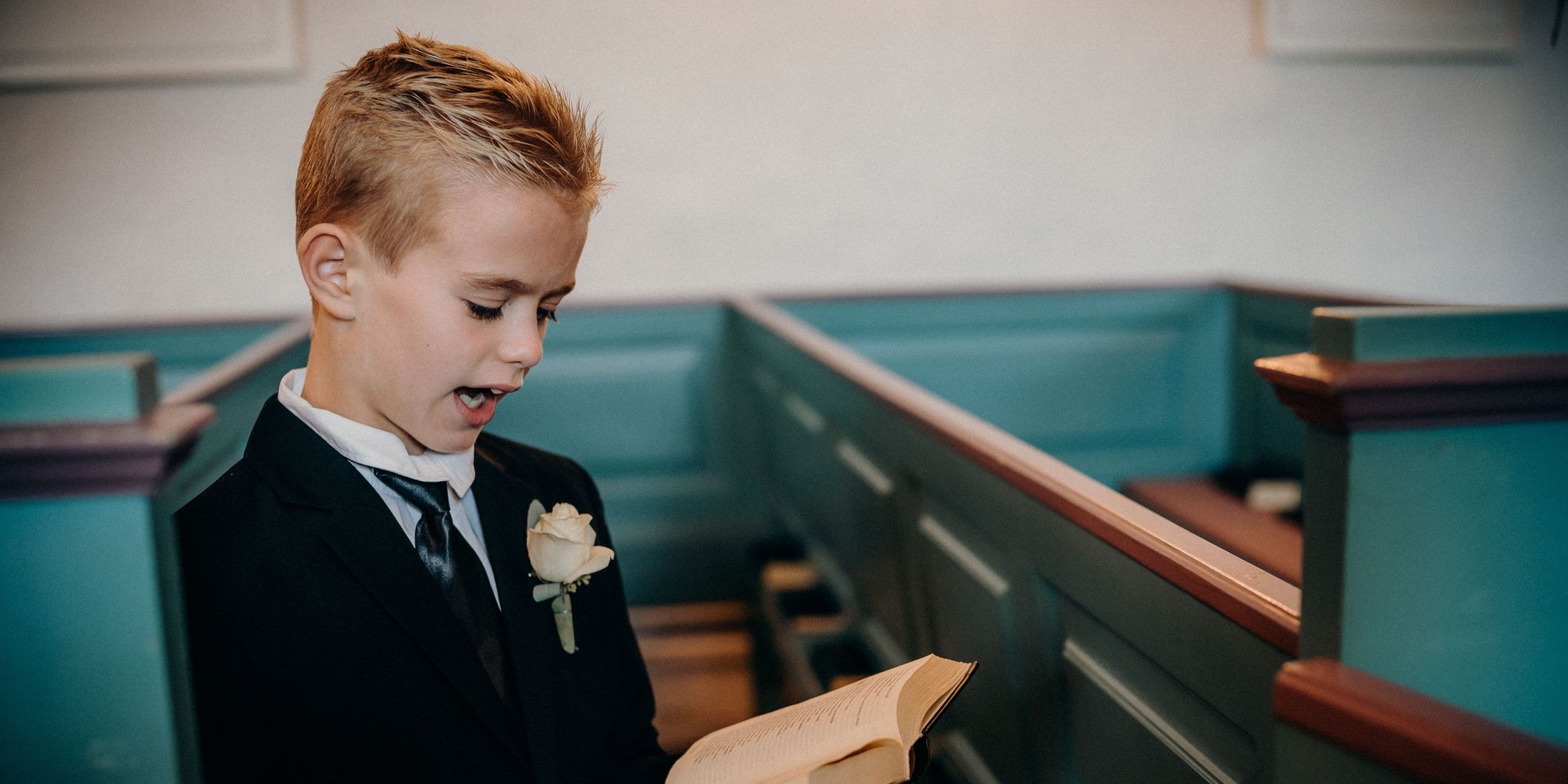 A boy reading inside a church | Source: Pexels