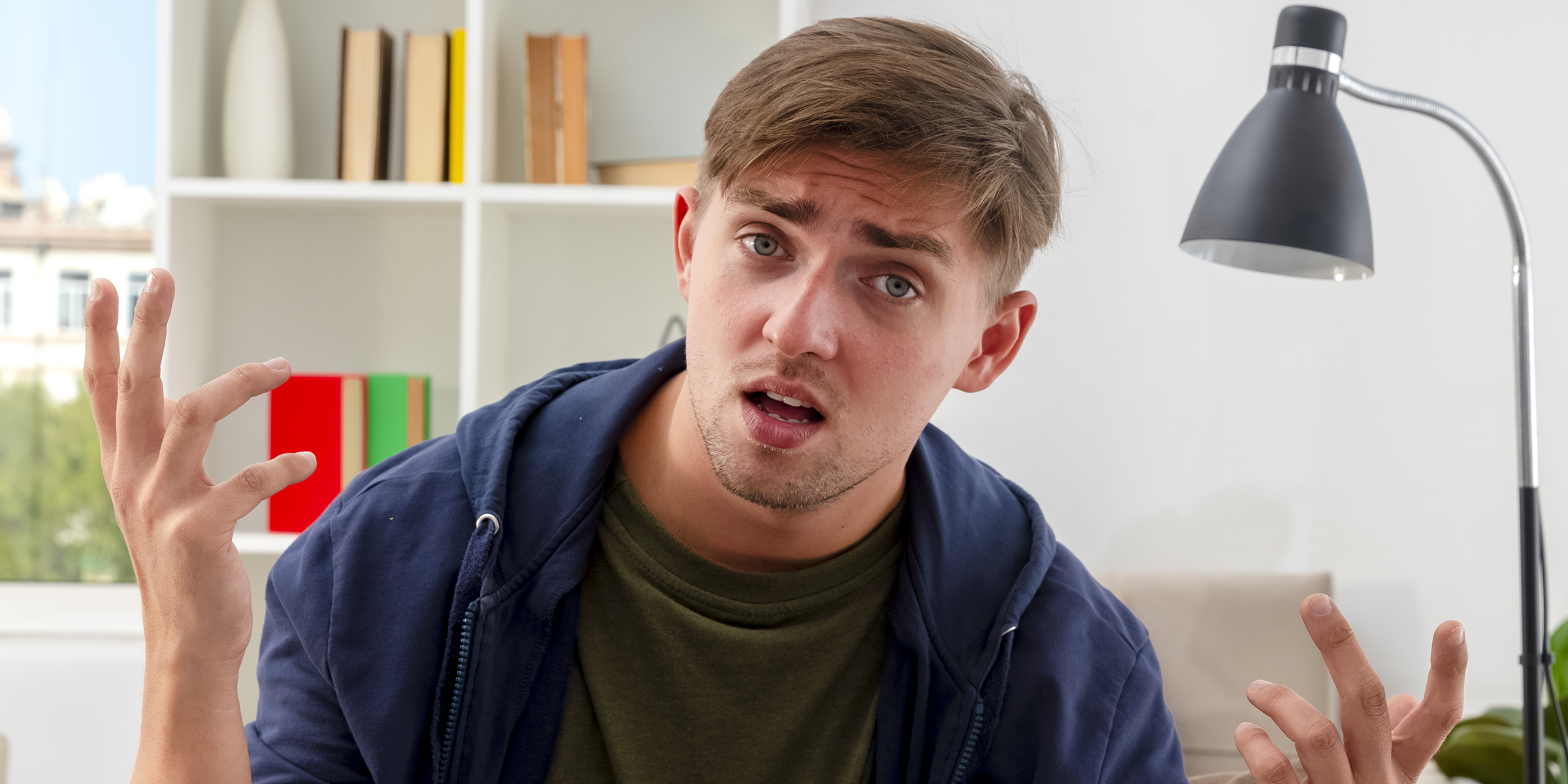 A confused and frustrated young man sitting indoors | Source: Freepik/stockking
