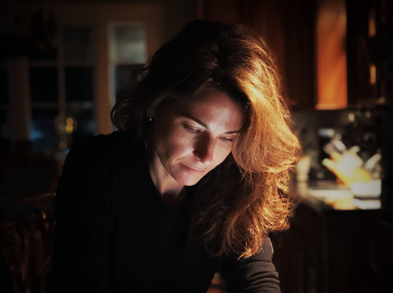 A woman sitting at a kitchen table at night | Source: Midjourney