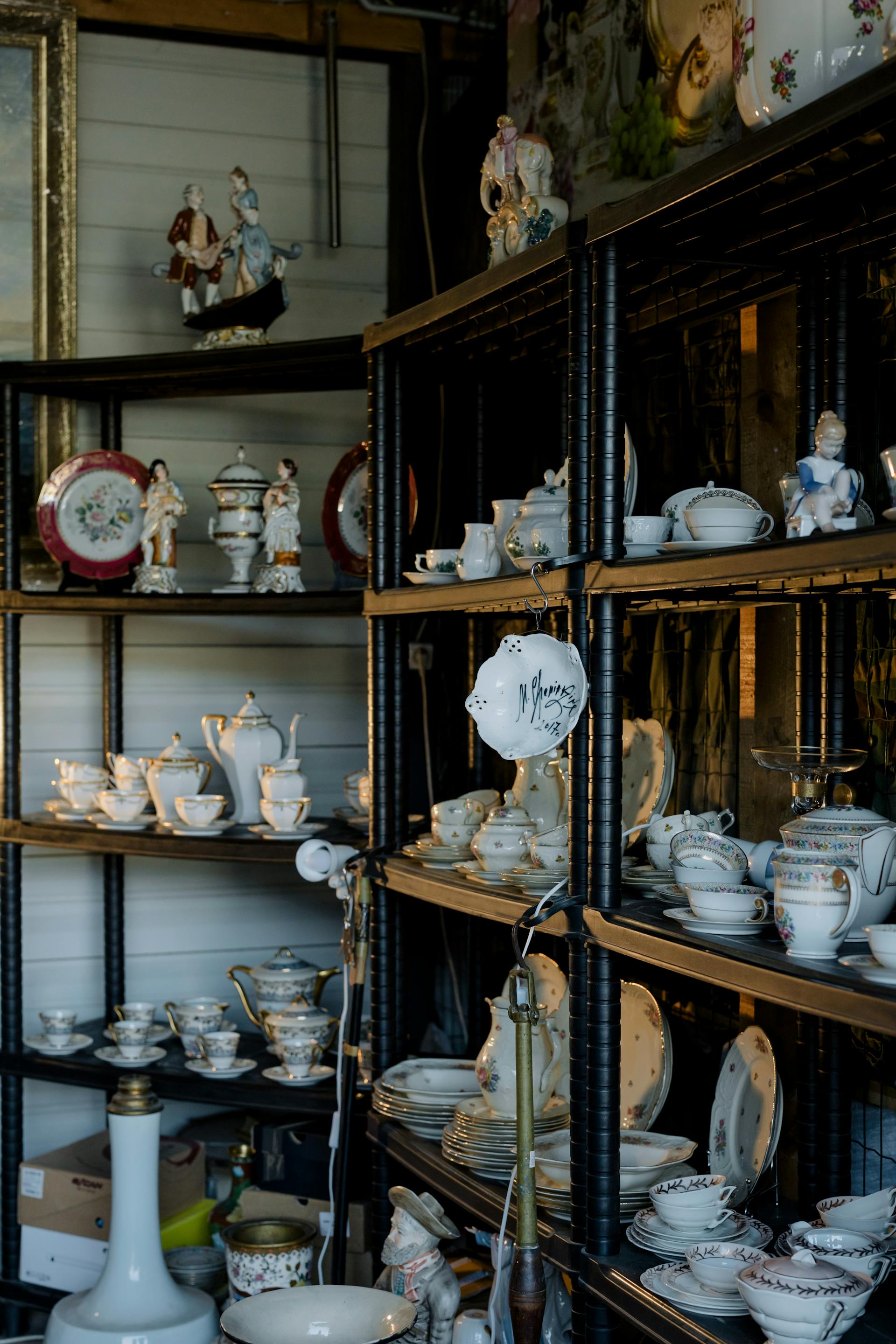 Cermanic figurines and tableware on shelves | Source: Pexels