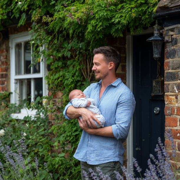 A man with his baby | Source: Midjourney