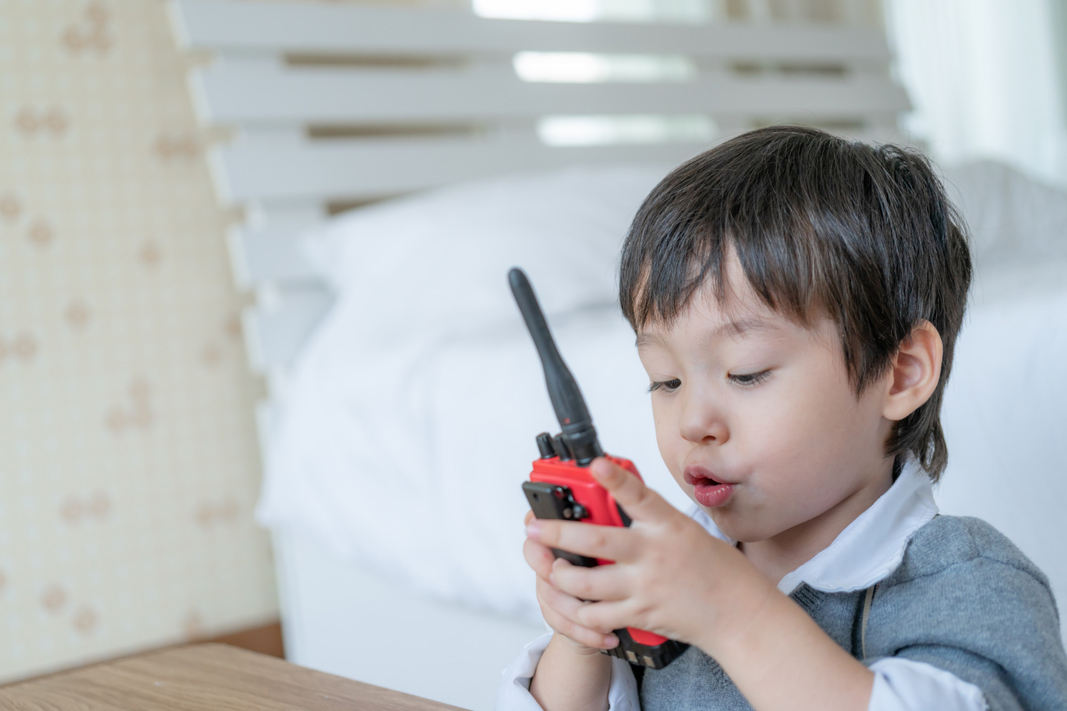 A little boy holding a walkie-talkie | Source: Freepik