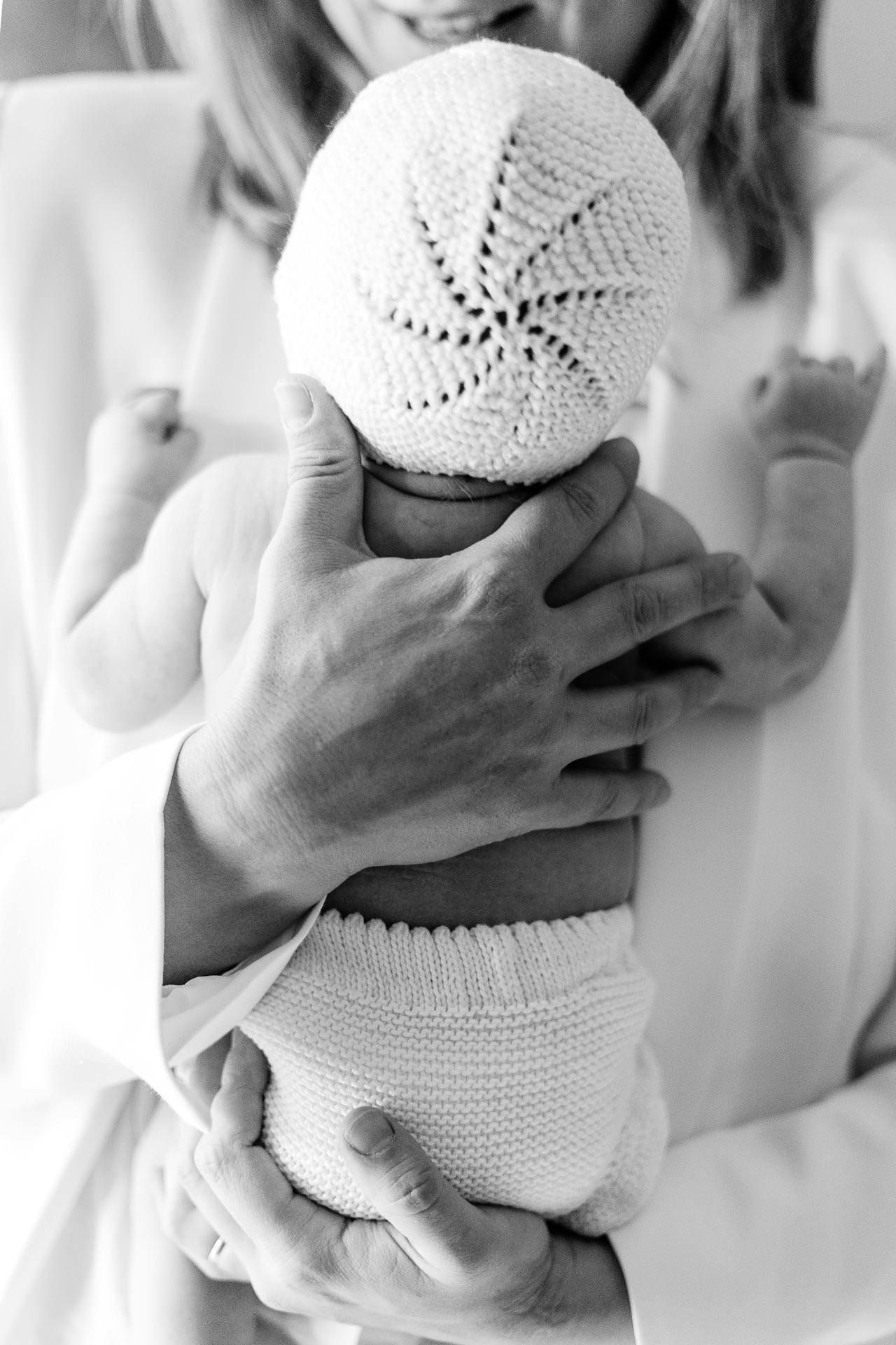 Grayscale shot of a mother holding her newborn baby | Source: Pexels