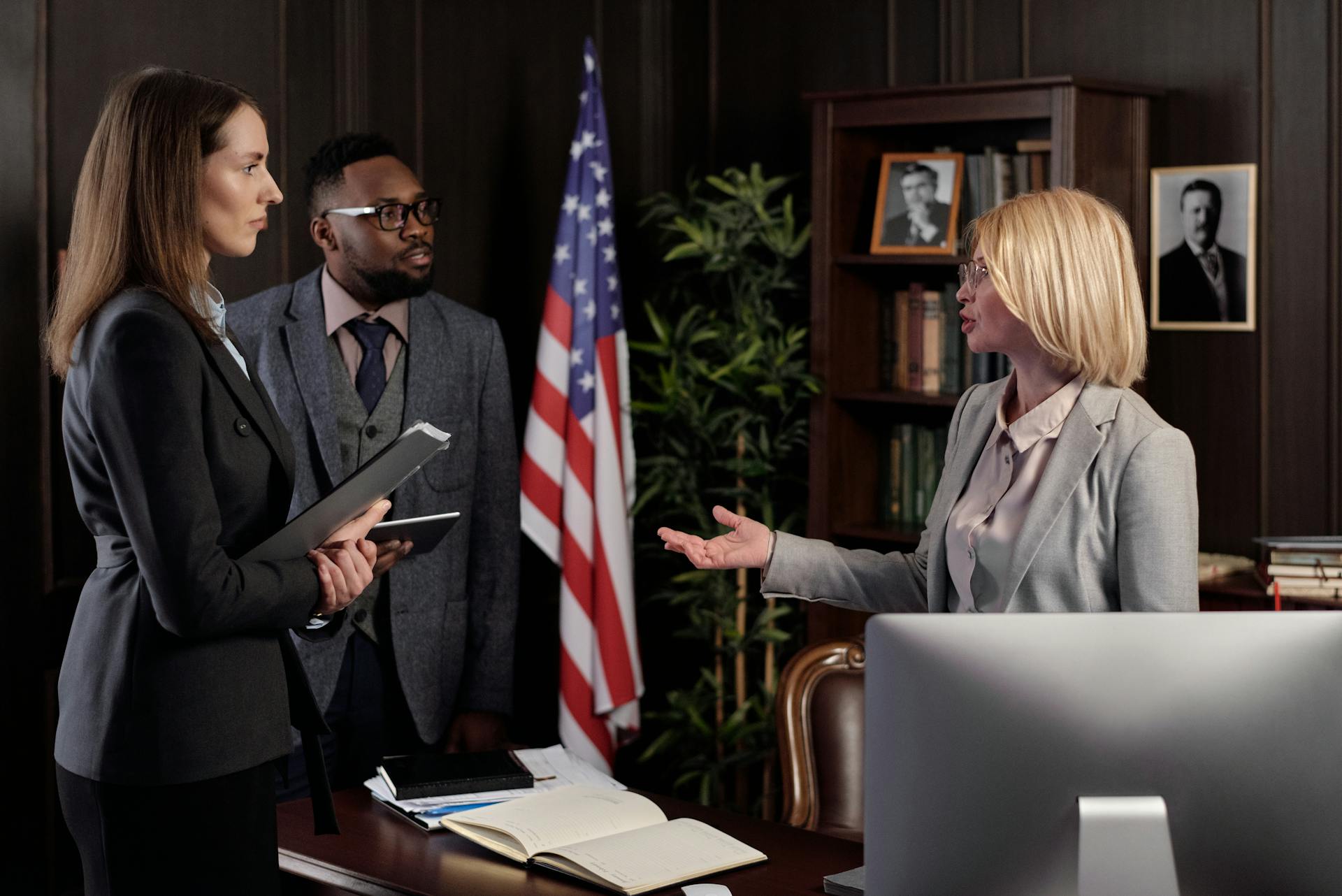 A lawyer conferring with her colleagues | Source: Pexels