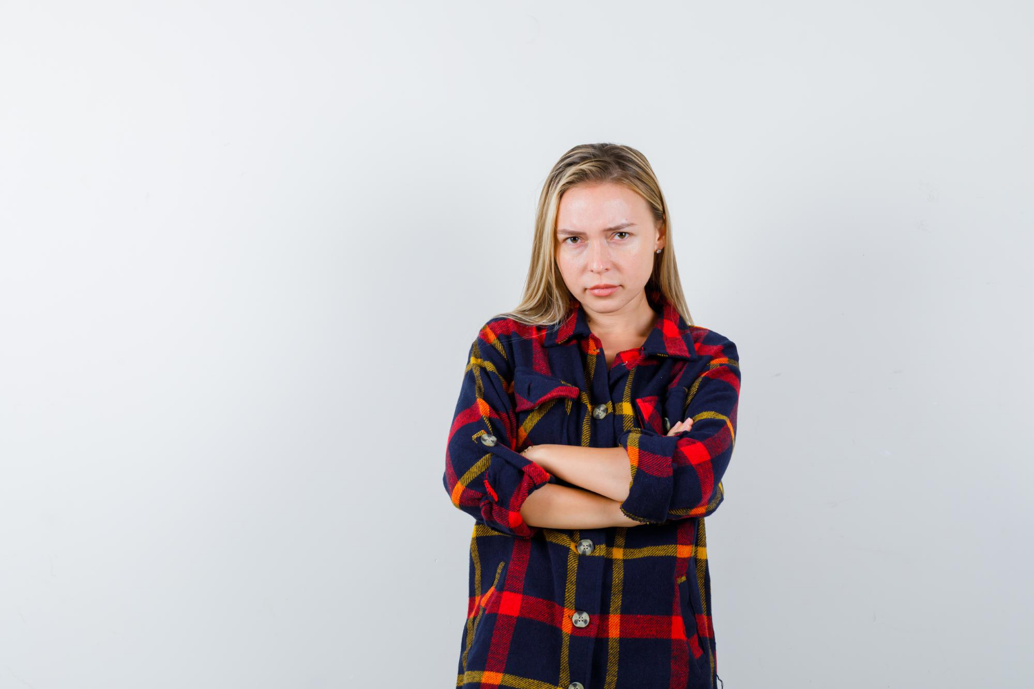 An annoyed young woman with her arms crossed | Source: Freepik