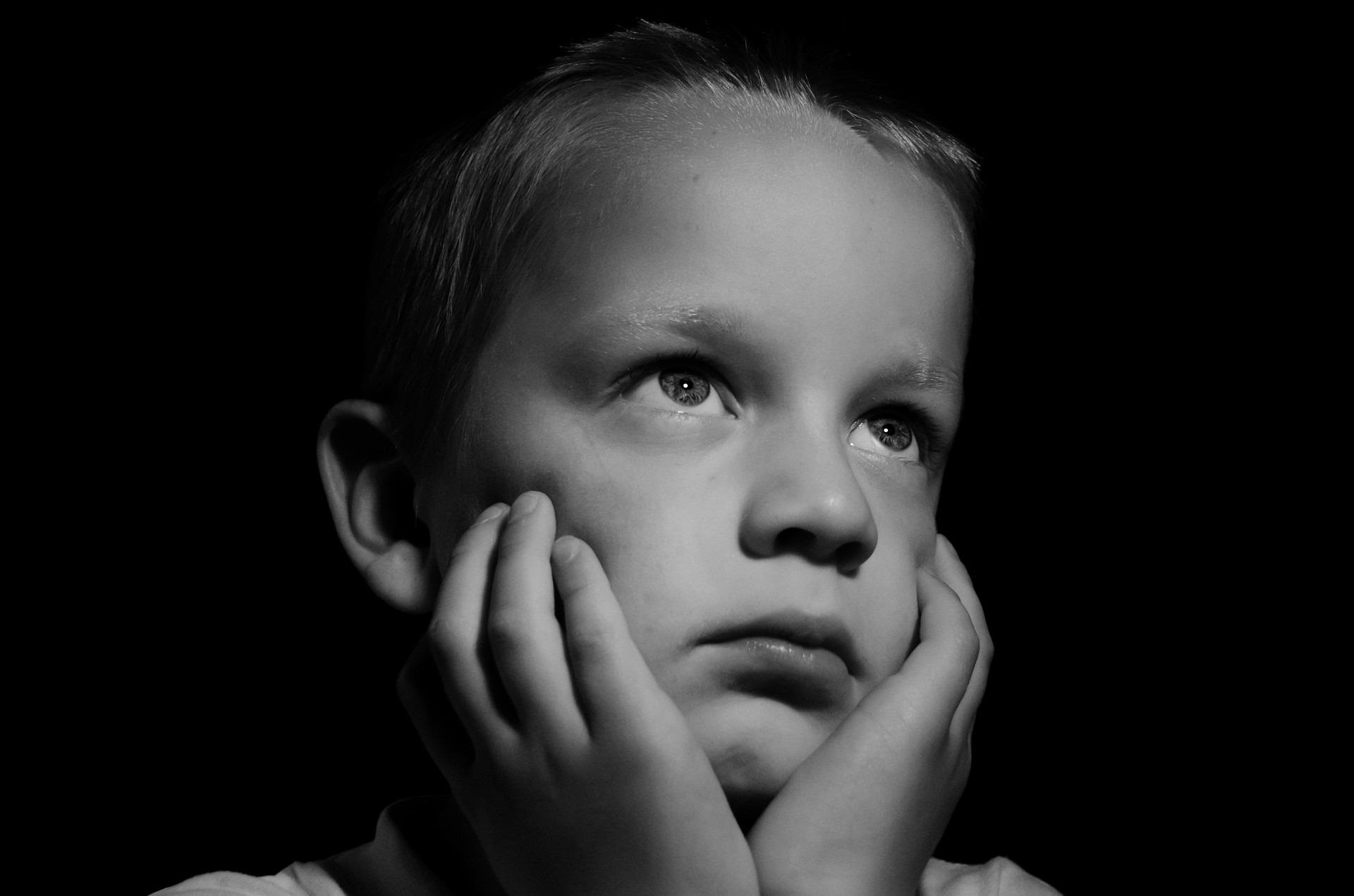 Grayscale shot of a desperate boy with hope and longing brimming in his eyes | Source: Pixabay