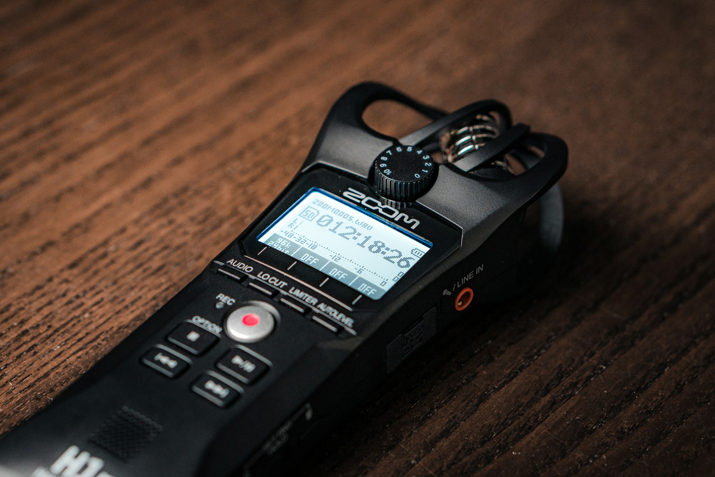 A small voice recorder placed on a brown table | Source: Unsplash