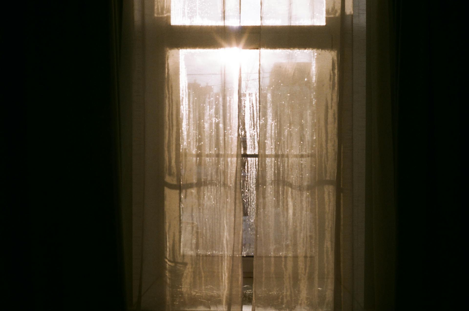 Daylight shining through a curtain | Source: Pexels