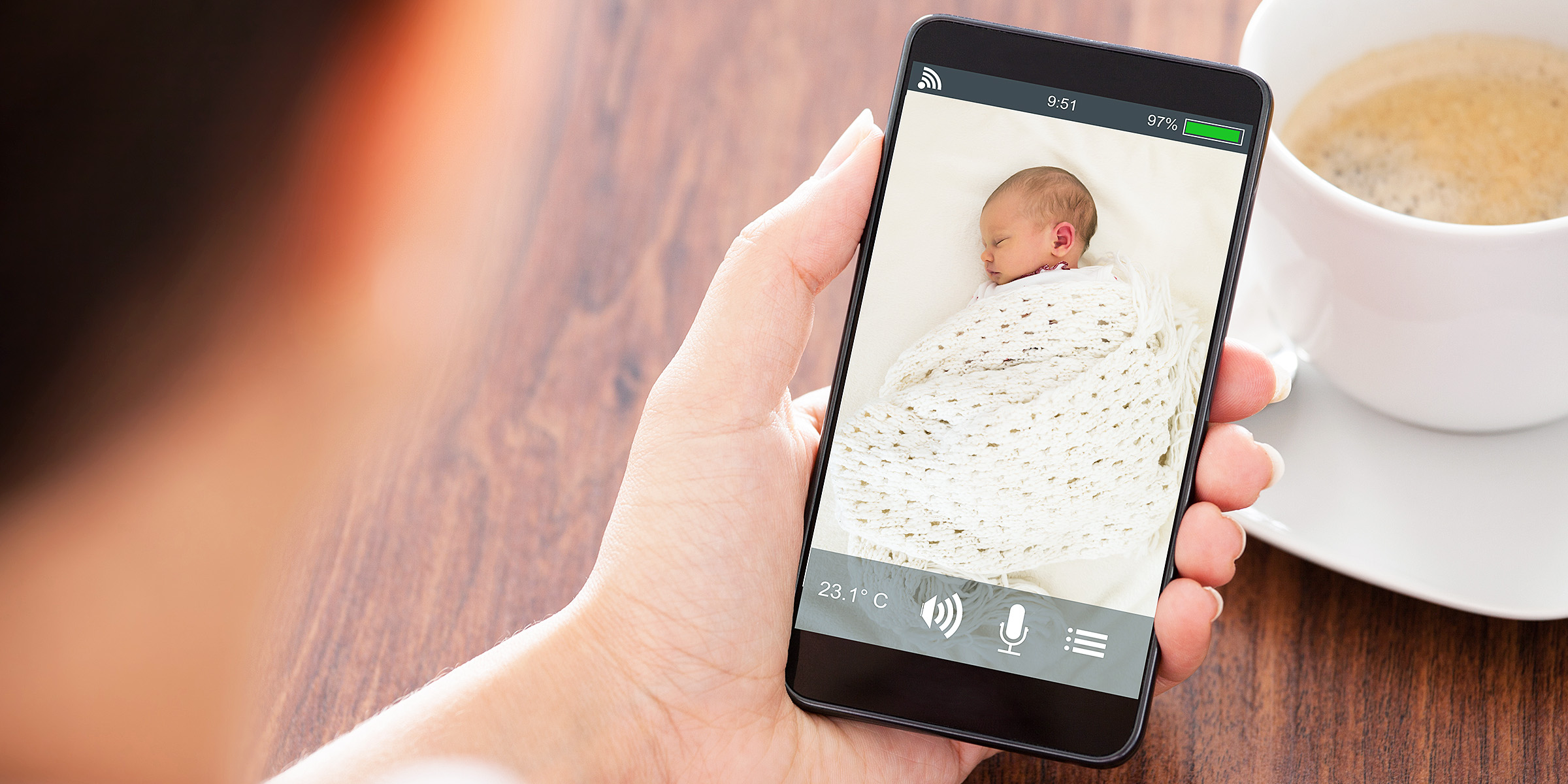 A person watching a baby sleep on the phone | Source: Shutterstock