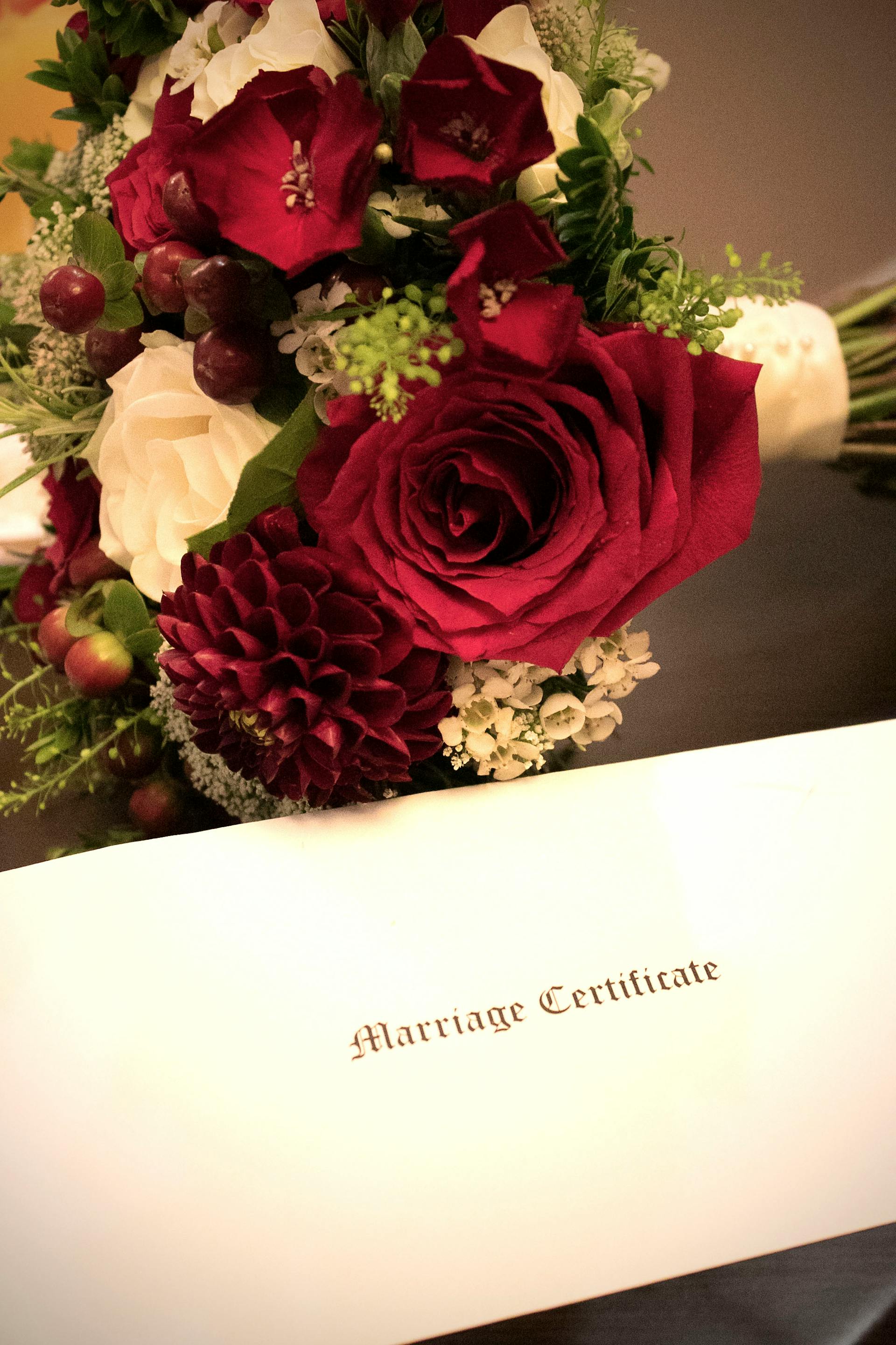 A bouquet beside a marriage certificate document | Source: Pexels
