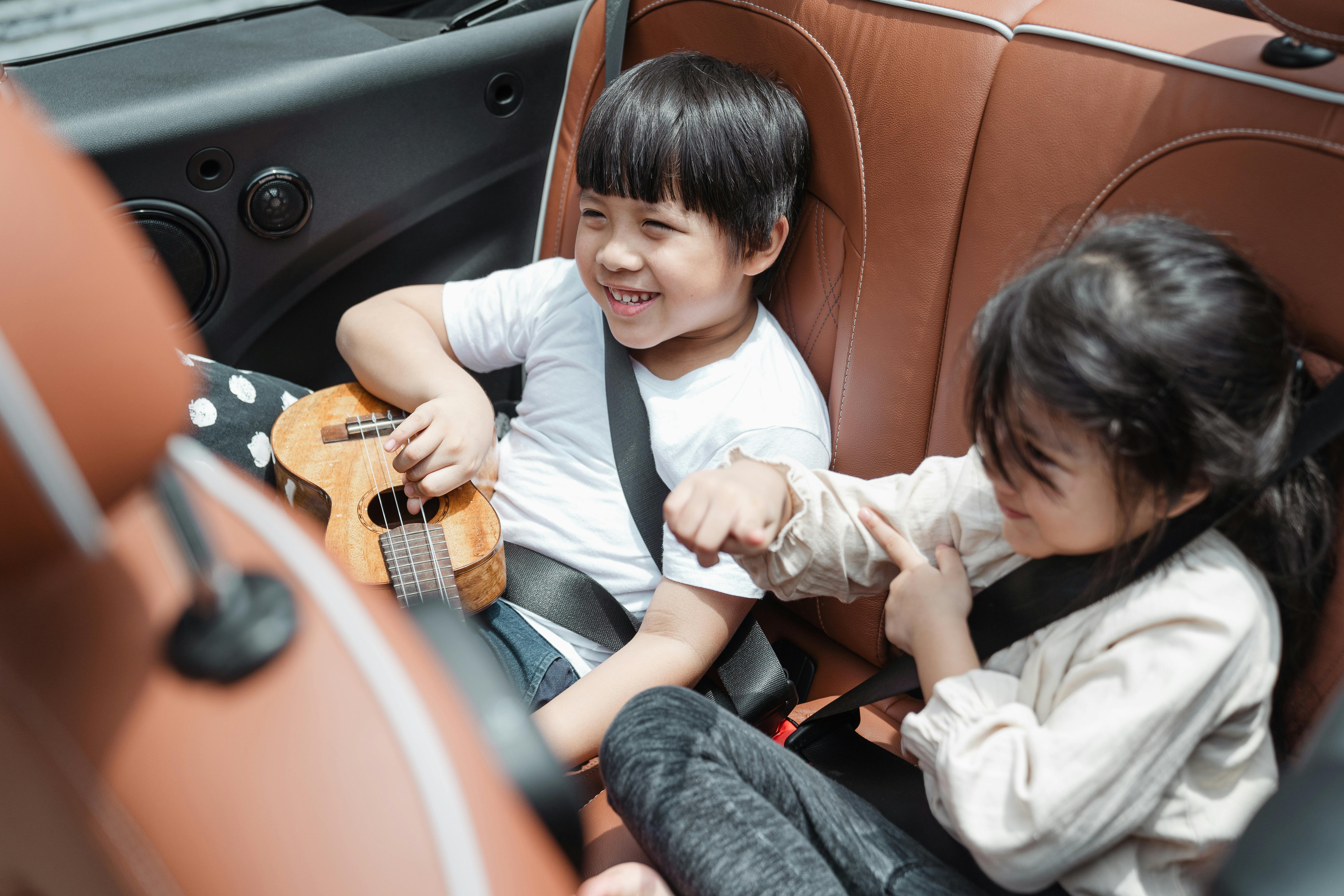 Excited children in the backseat of a car | Source: Pexels