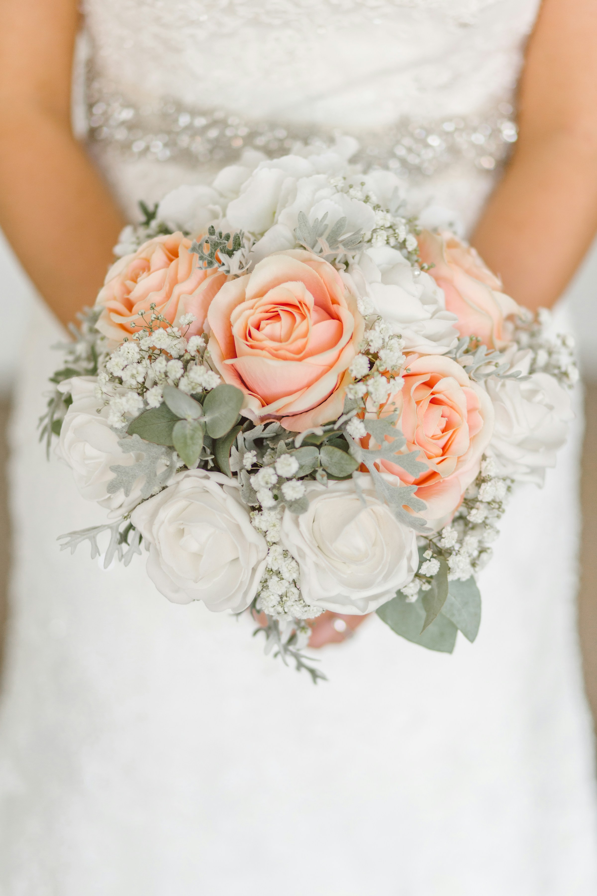 A close-up shot of a bride holding a bouquet | Source: Unsplash