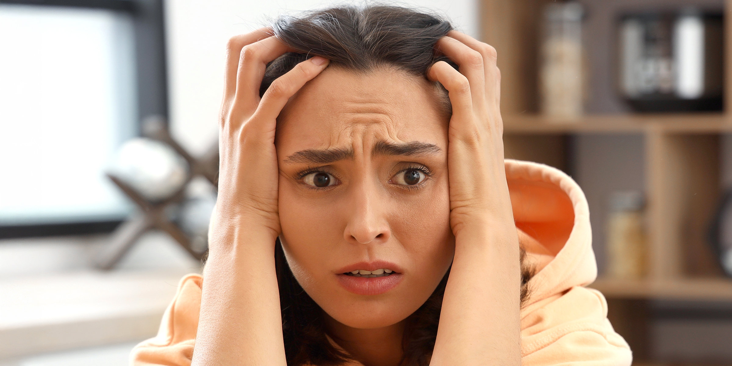 A tense woman with her head in her hands | Source: Shutterstock