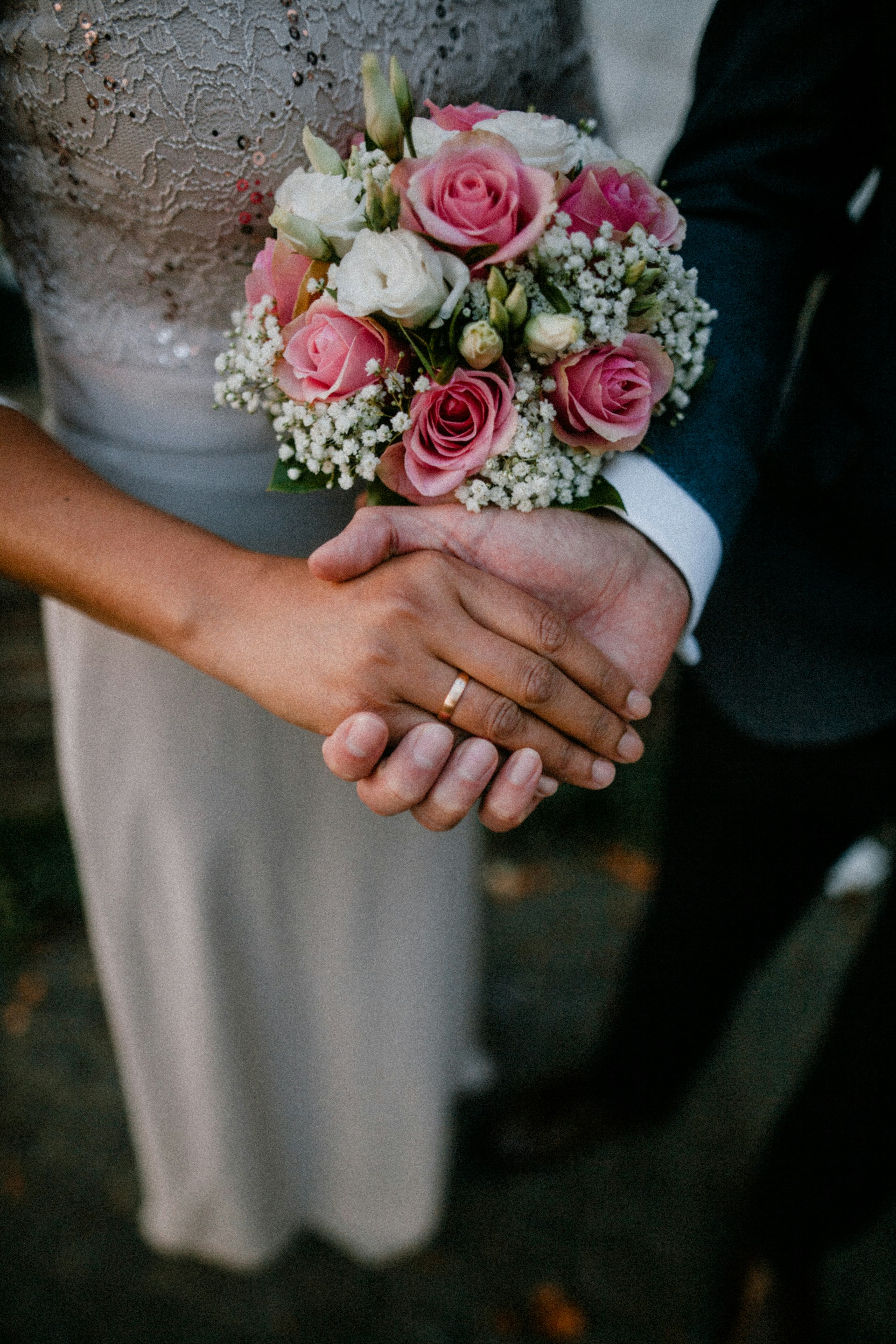 A groom holding his bride's hand | Source: Unsplash