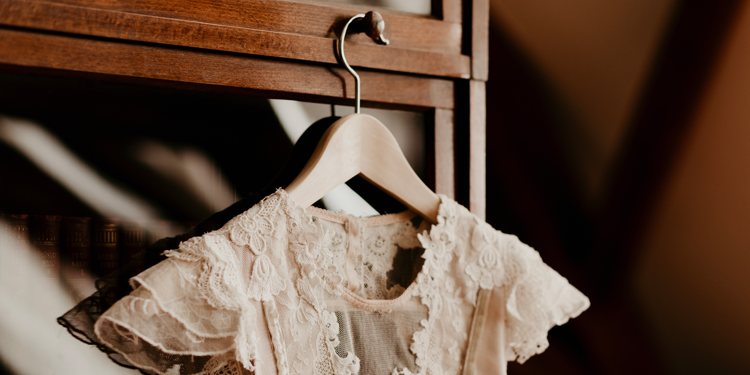 A vintage wedding dress hanging on a closet | Source: Shutterstock