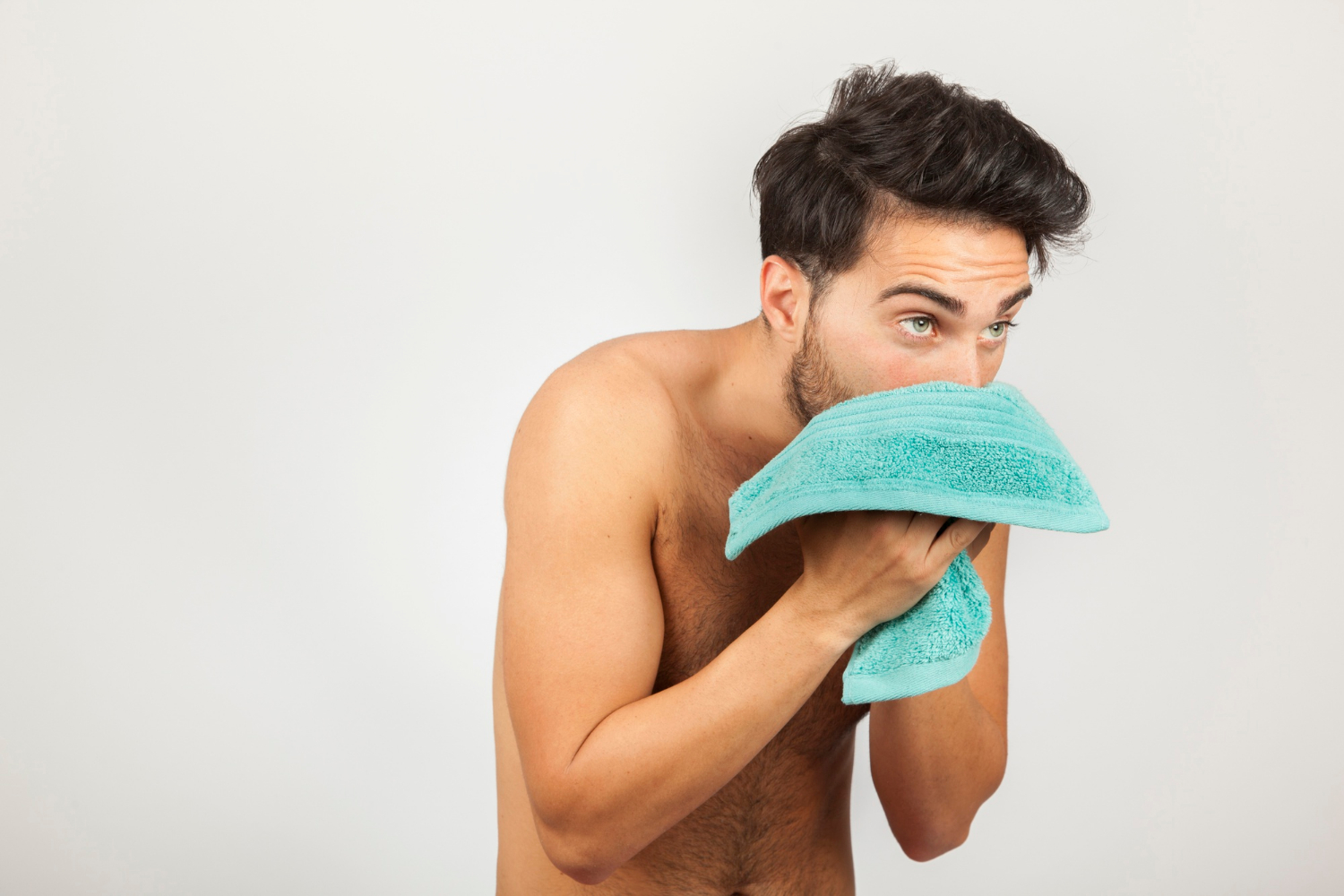 A man wiping his face with a towel | Source: Freepik