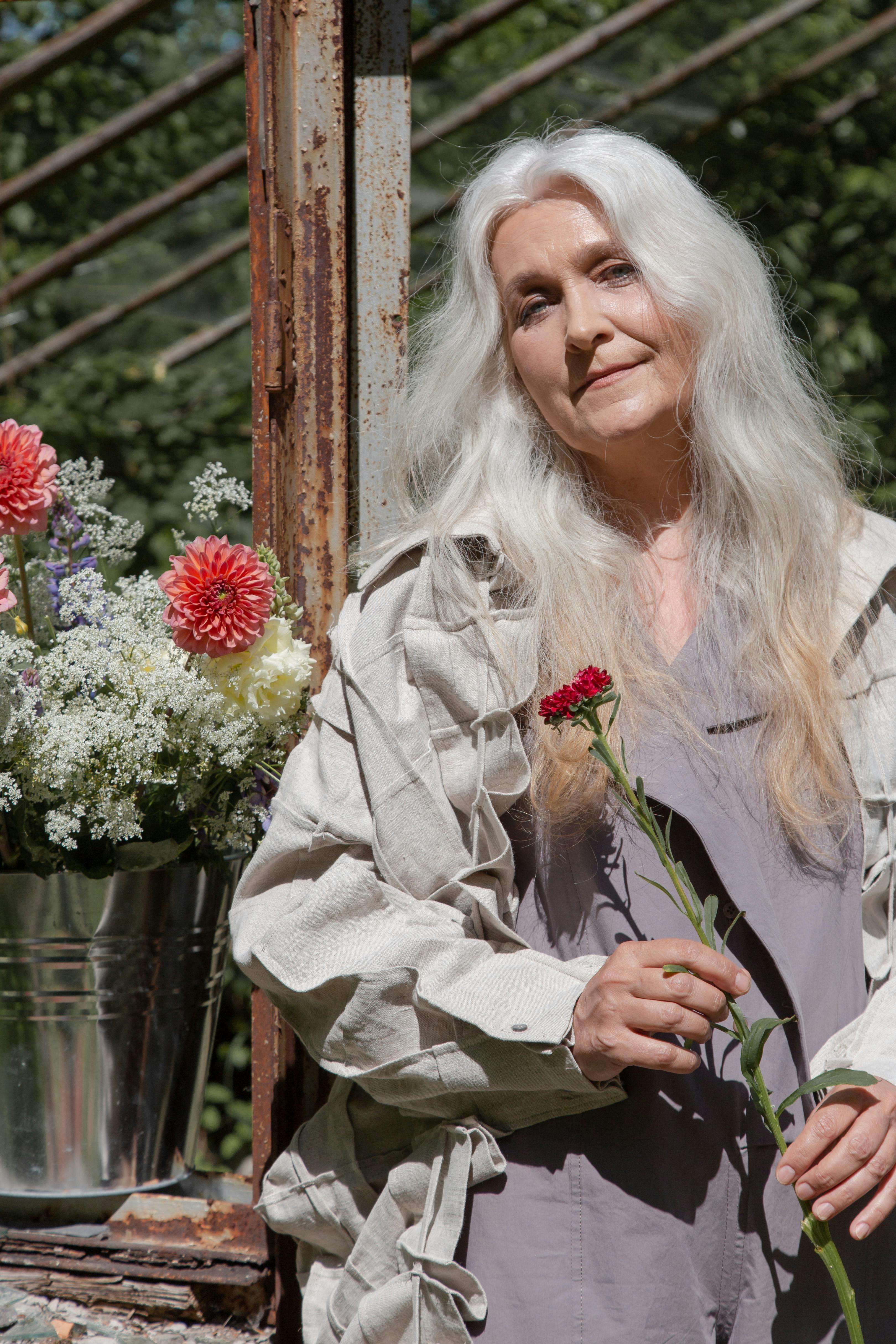 An elderly woman in her garden | Source: Pexels