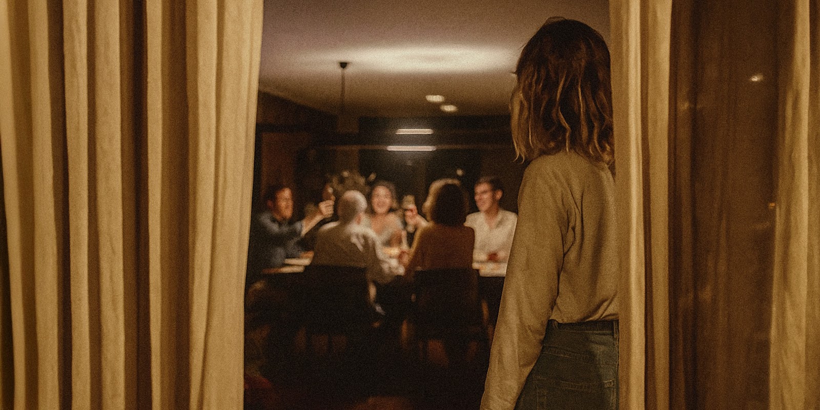 Woman observing a family gathering. | Source: Sora