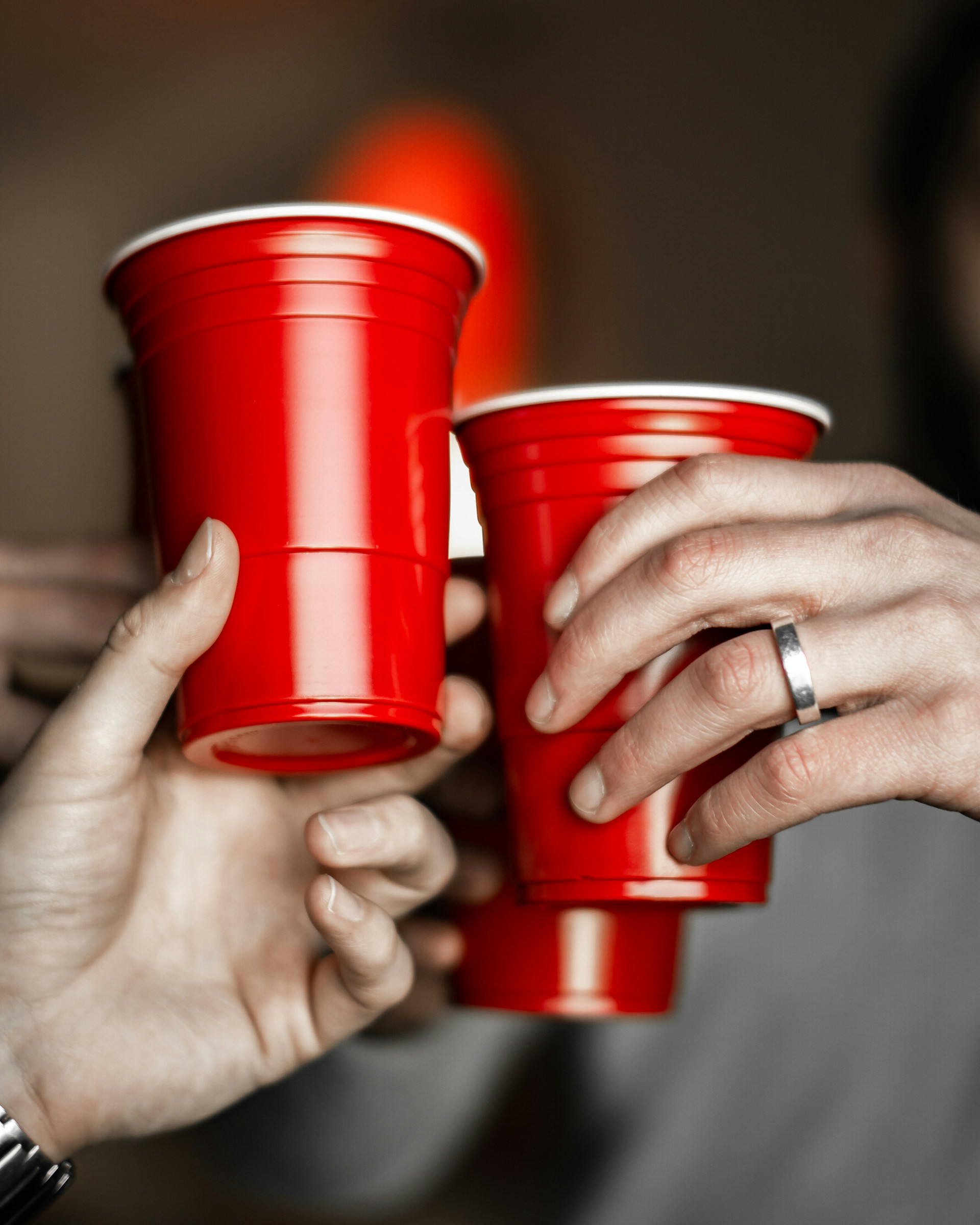 A group of men holding red cups | Source: Unsplash