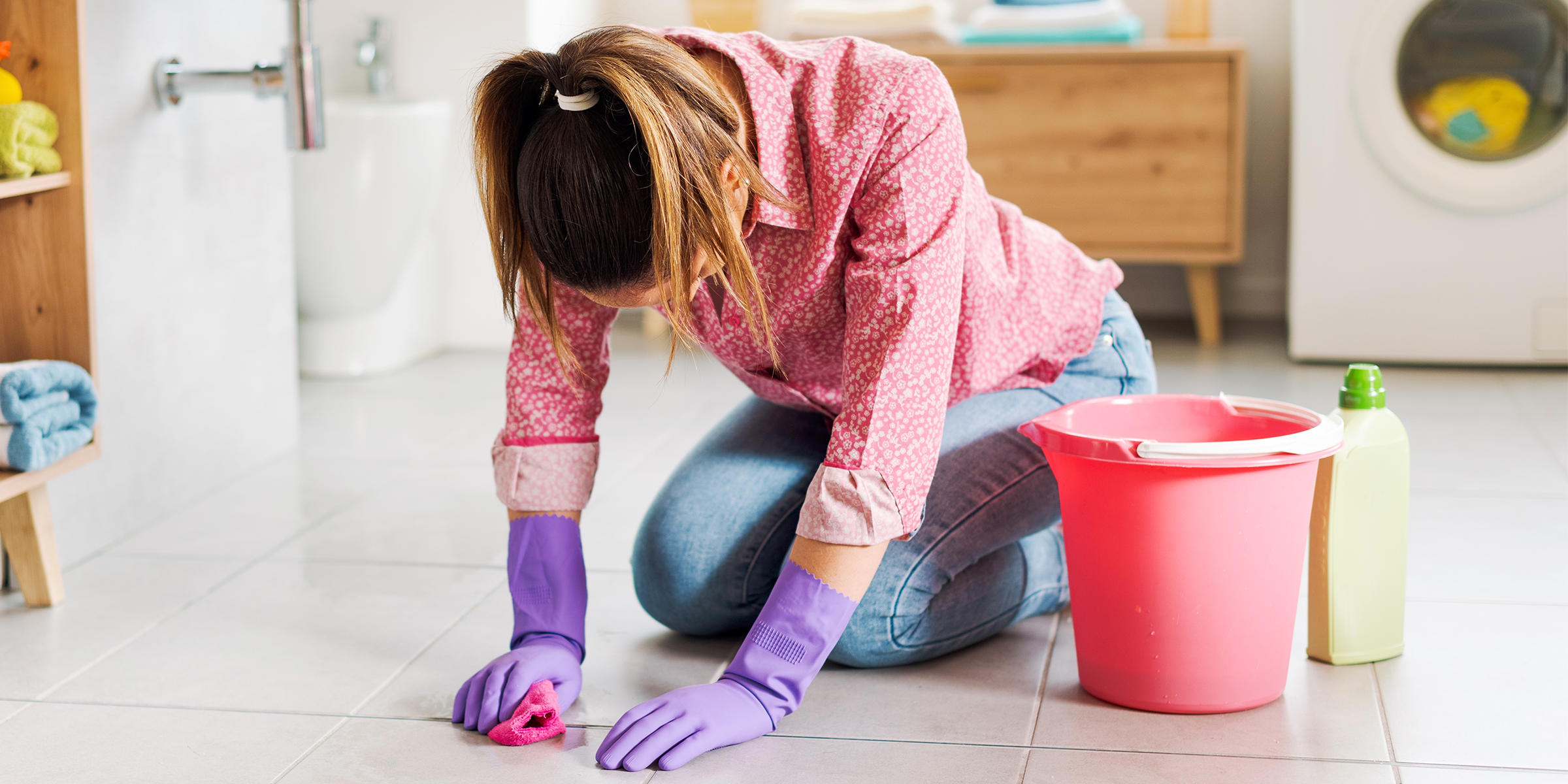 A woman scrubbing the floor | Source: Shutterstock