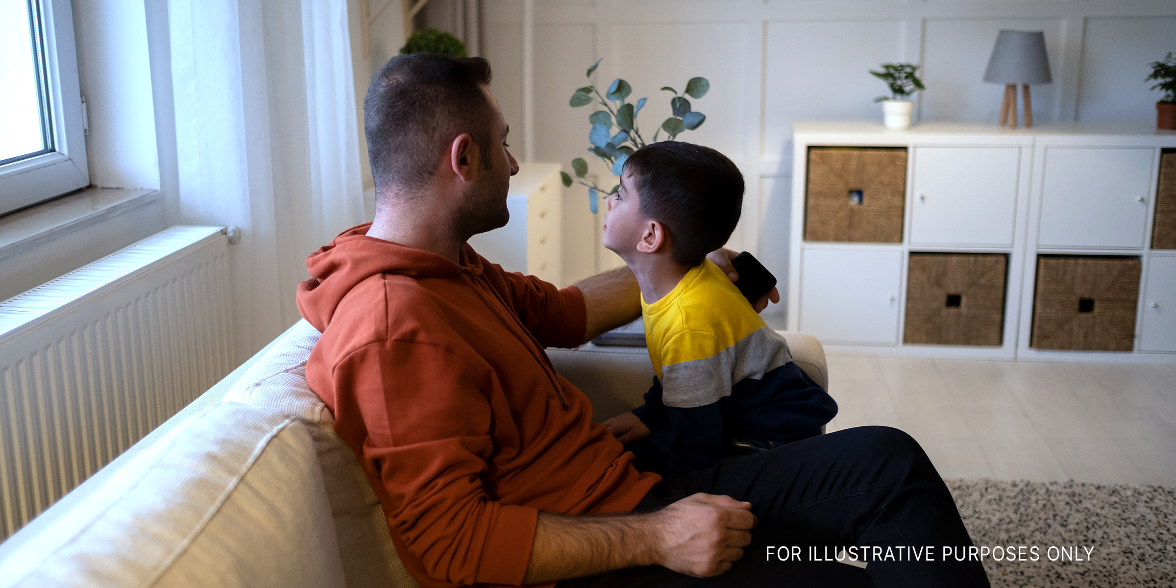 A man sitting with his son | Source: Getty Images