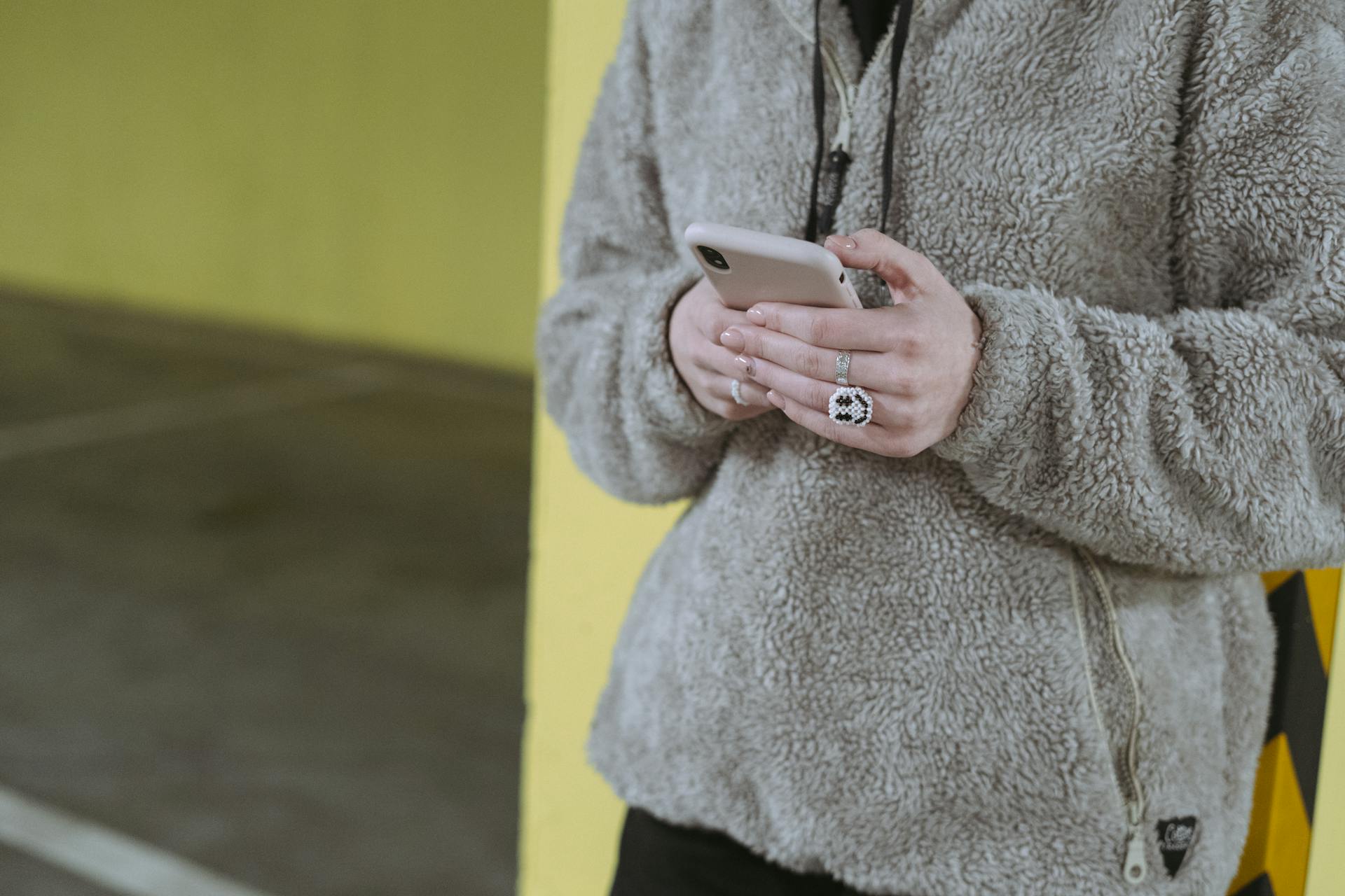 A woman holding her phone | Source: Pexels