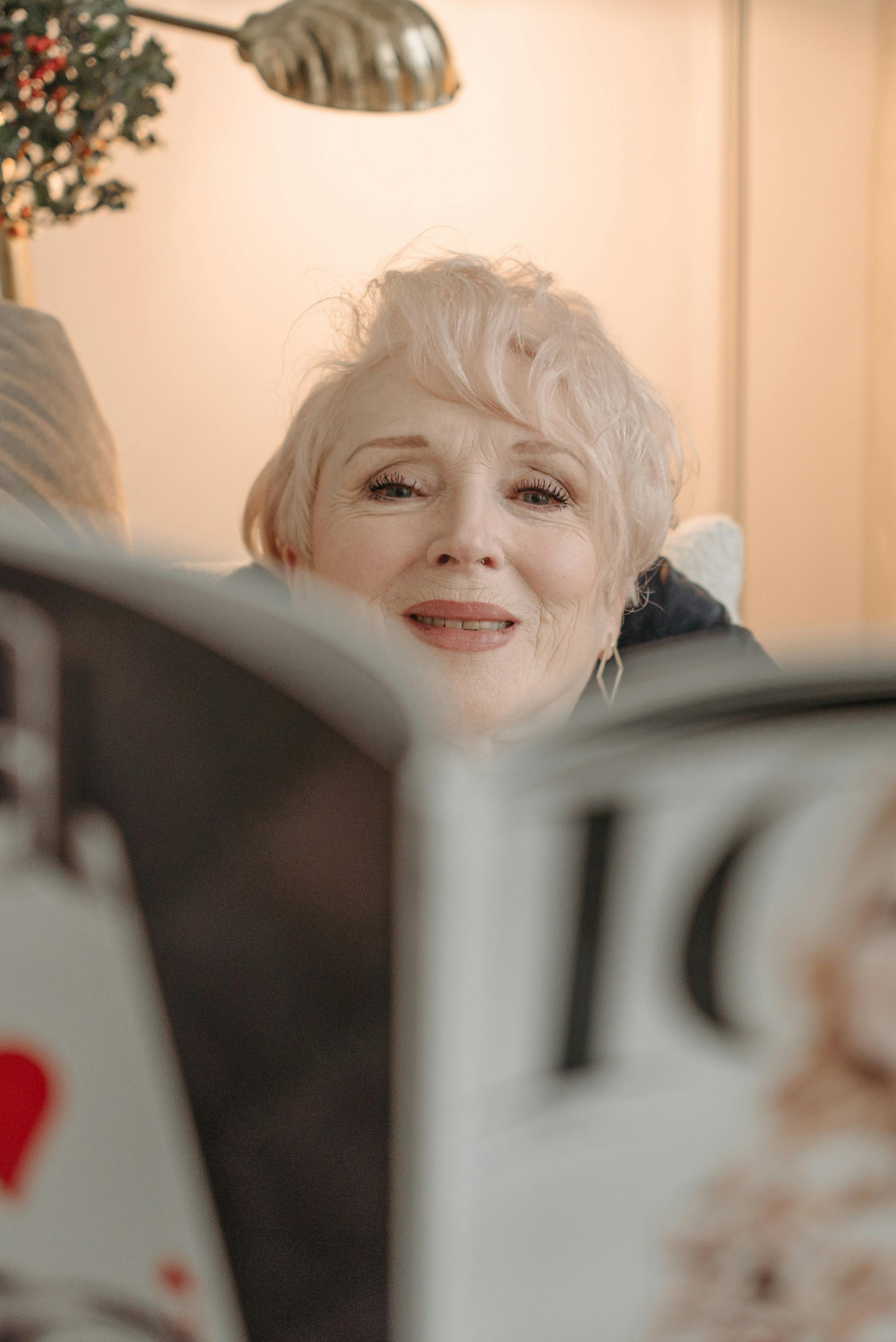 A happy woman looking through a magazine | Source: Pexels