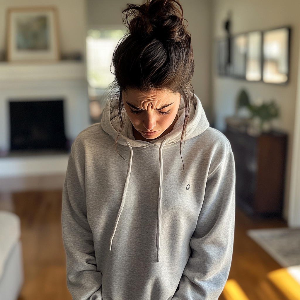 A woman with a messy bun and a hoodie | Source: Midjourney