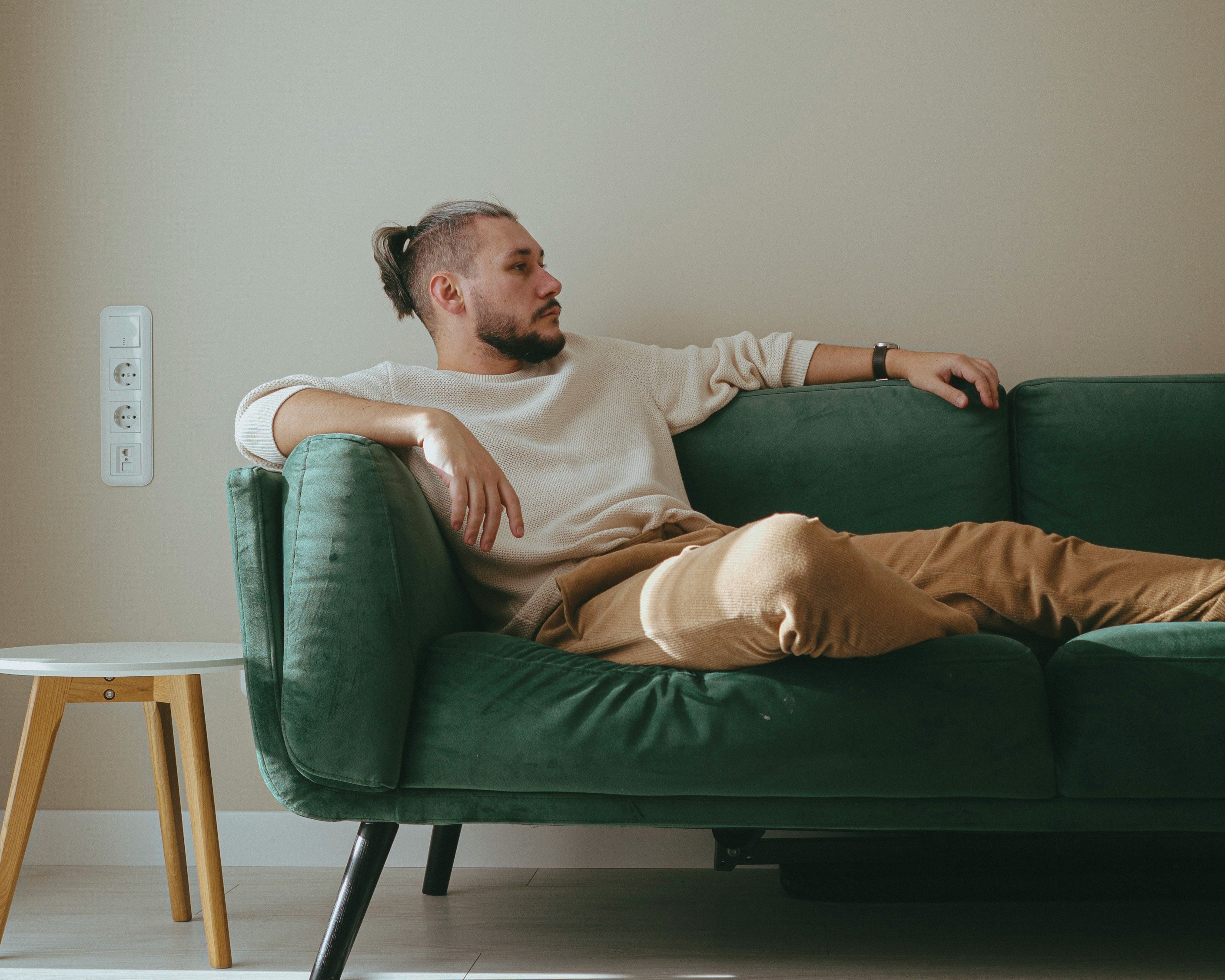 A man sitting on a couch | Source: Unsplash