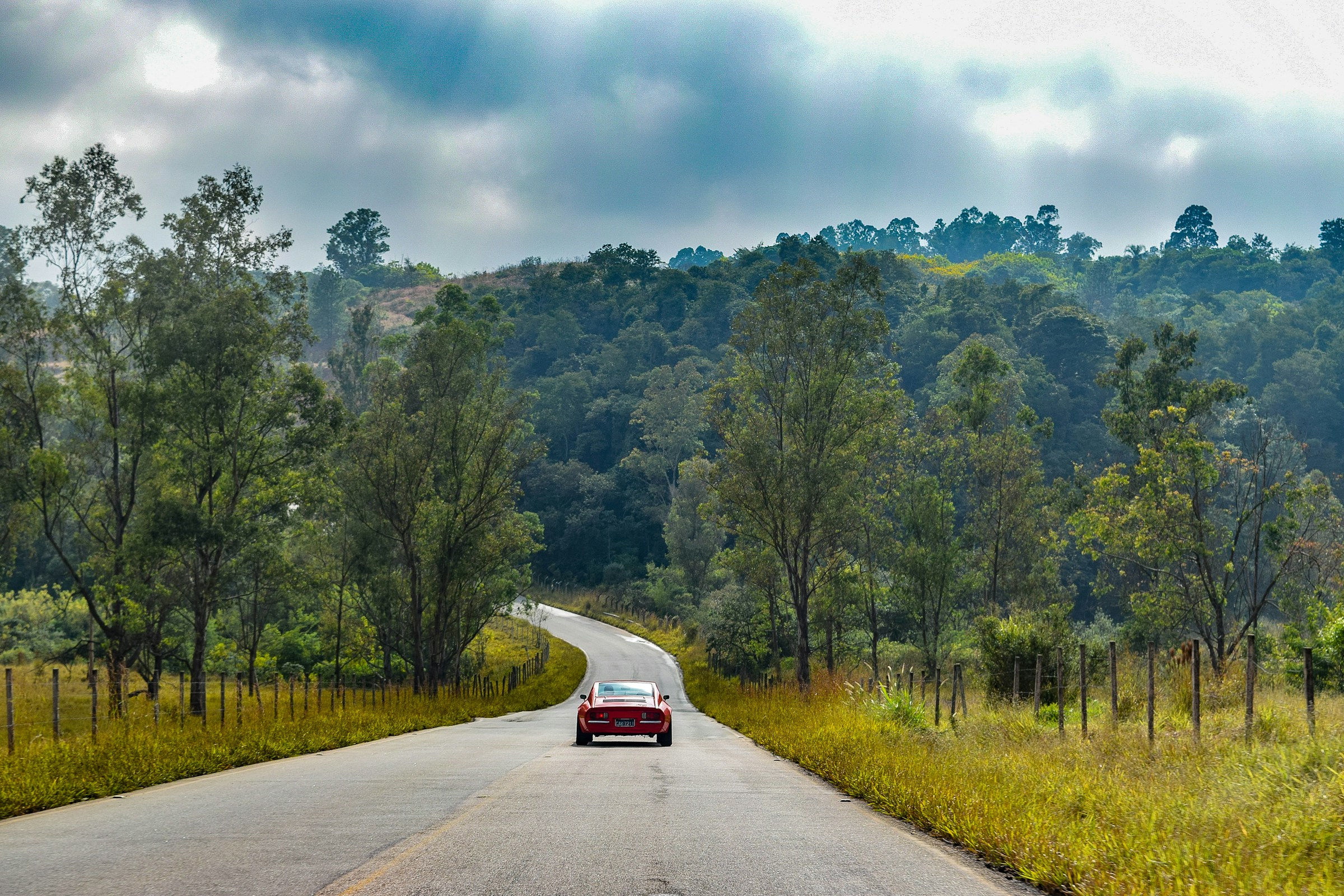 A red car on a road | Source: Unsplash